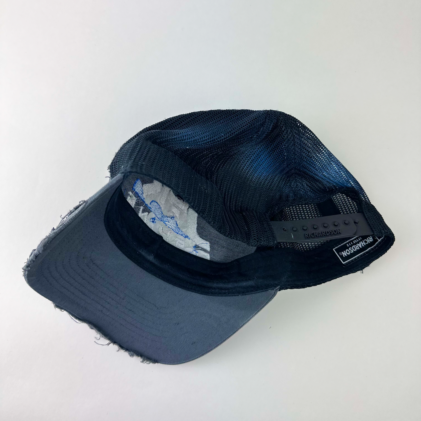 ASTROBOI* 'JFK Fishing' gray rhinestone trucker cap, rear view showing mesh back panel and adjustable strap.