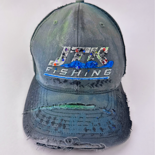 ASTROBOI* 'JFK Fishing' gray rhinestone trucker cap with rhinestone-embellished embroidered logo, blue wave design, and deconstructed visor, front view.