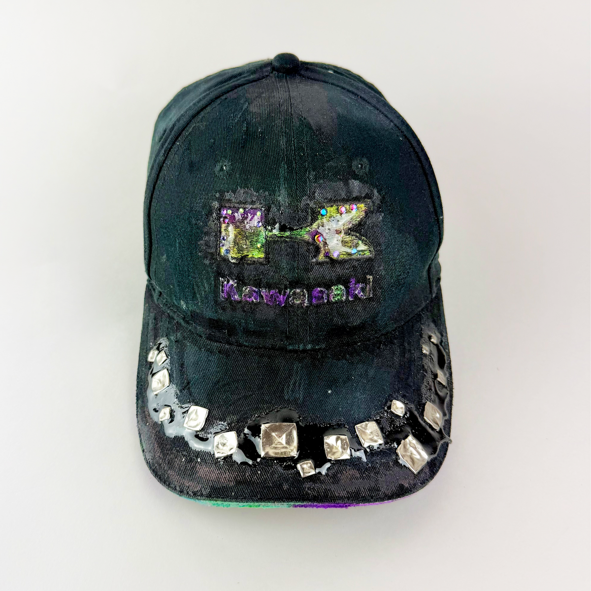 ASTROBOI* x Kawasaki 'Cold Visions' black rhinestone studded deconstructed hat with embellished Kawasaki logo, resin-covered studs, and distressed visor.