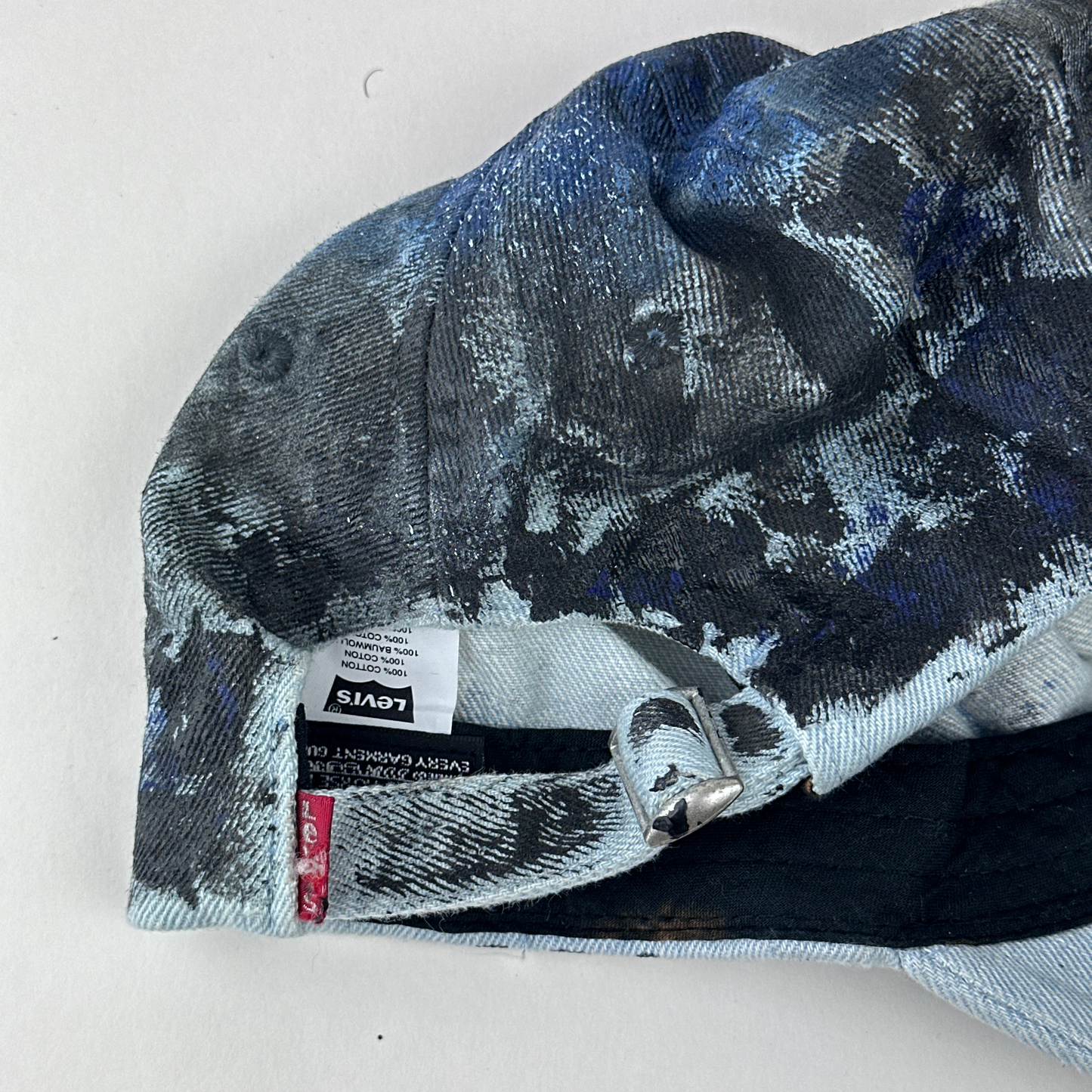 ASTROBOI* x Levi's 'Blacked Out' blue and black grunge denim hat, rear view showing adjustable strap back.