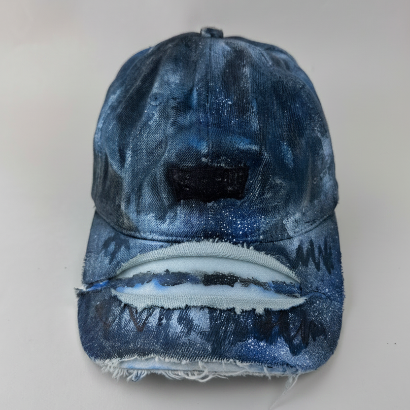 ASTROBOI* x Levi's 'Blacked Out' blue and black grunge denim hat with blacked out Levi's tab logo at front, custom paint treatment, and deconstructed visor, front view.