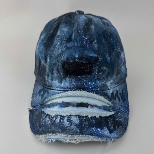 ASTROBOI* x Levi's 'Blacked Out' blue and black grunge denim hat with blacked out Levi's tab logo at front, custom paint treatment, and deconstructed visor, front view.