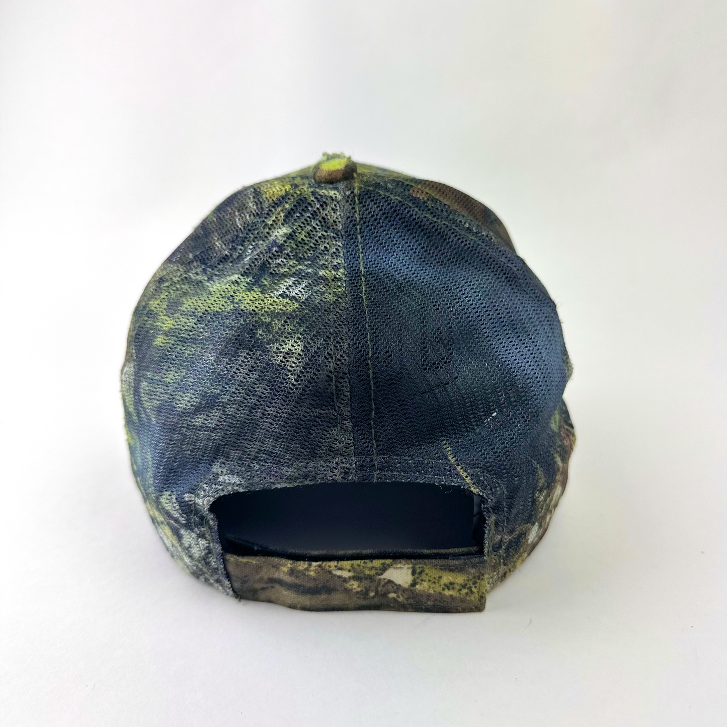 ASTROBOI* 'Mountains' brown Real Tree trucker hat, rear view showing mesh back panel and adjustable strap.