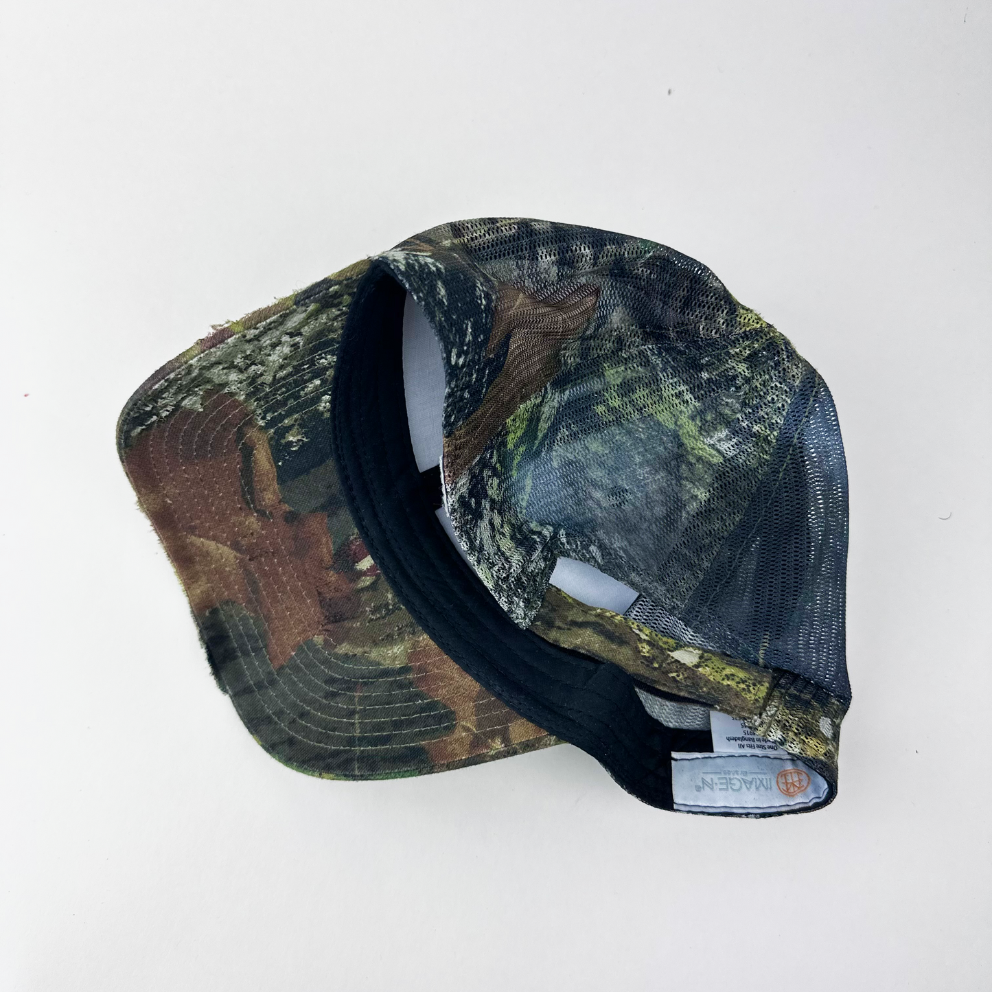 ASTROBOI* 'Mountains' brown Real Tree trucker hat, rear view showing mesh back panel and adjustable strap.