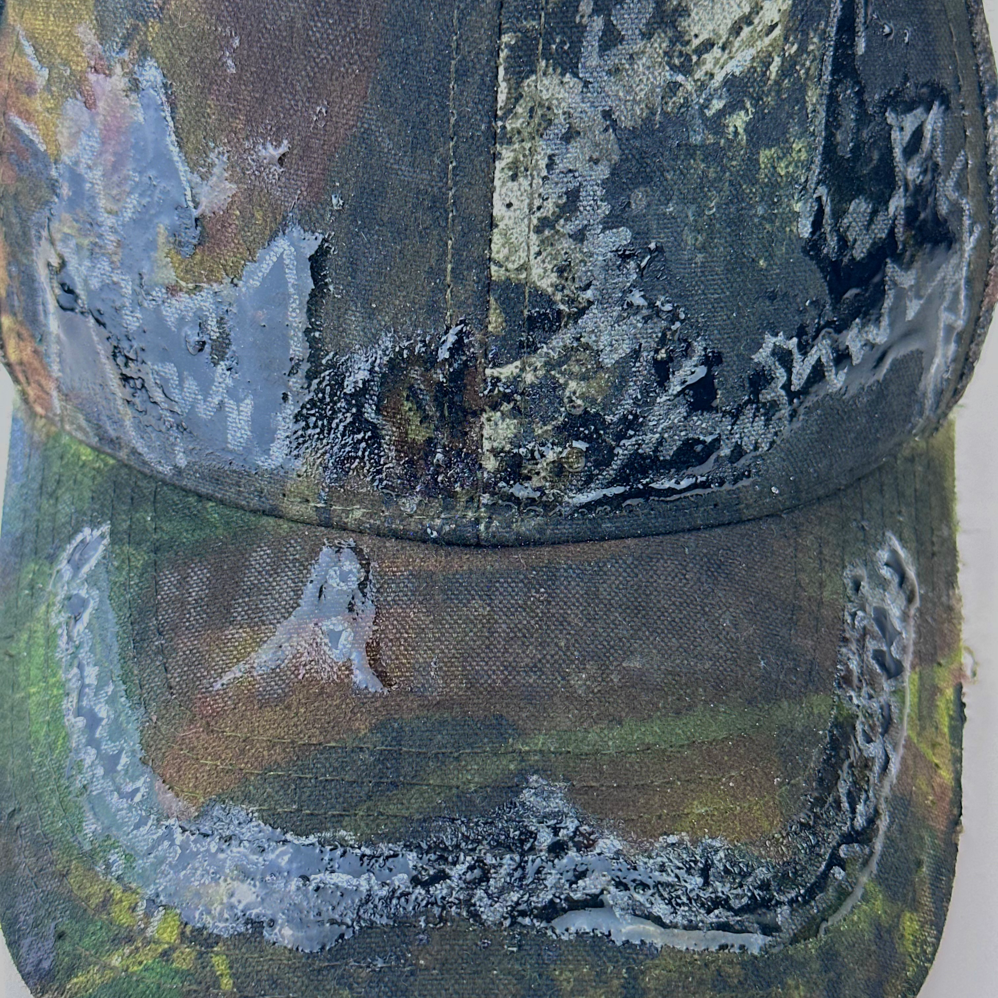 Close-up of ASTROBOI* 'Mountains' showing hand drawn black and silver design detail sealed under clear resin on Real Tree camouflage fabric.