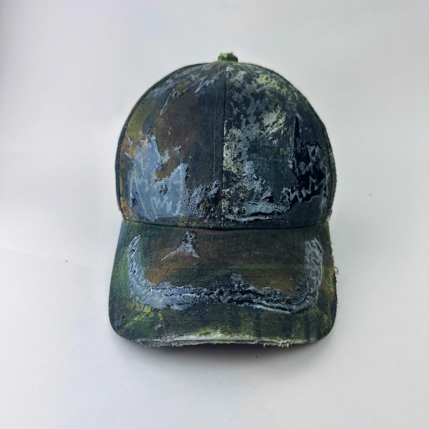 ASTROBOI* 'Mountains' brown Real Tree camouflage trucker hat with hand drawn black and silver design sealed under clear resin at front, front view two.