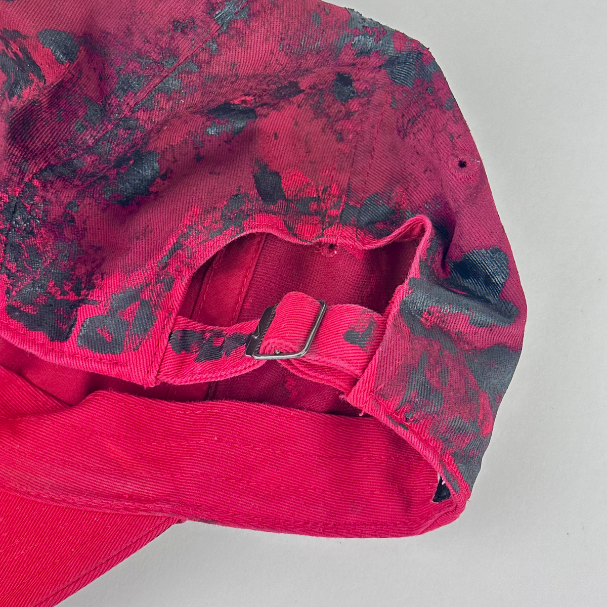 ASTROBOI* x Nike 'Comet' red and black painted distressed rhinestone hat, rear view showing adjustable back close up.