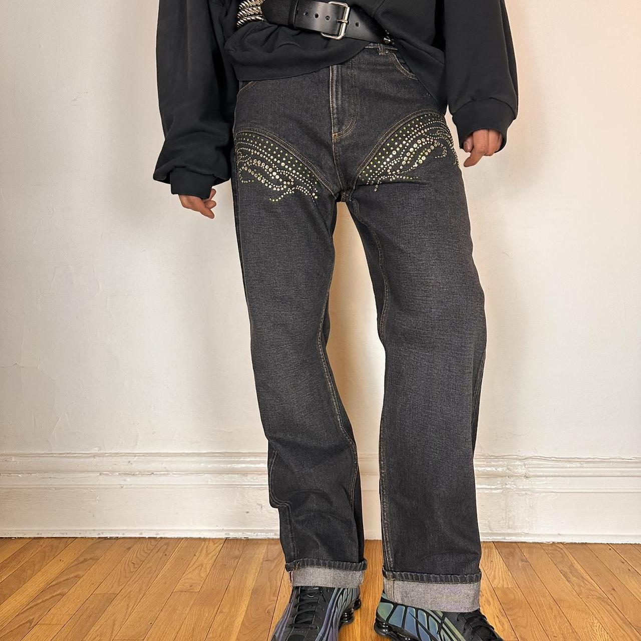 Styled photo of Y/PROJECT black western cowboy jeans with green and clear rhinestones along both legs, straight-leg fit, size 36x32