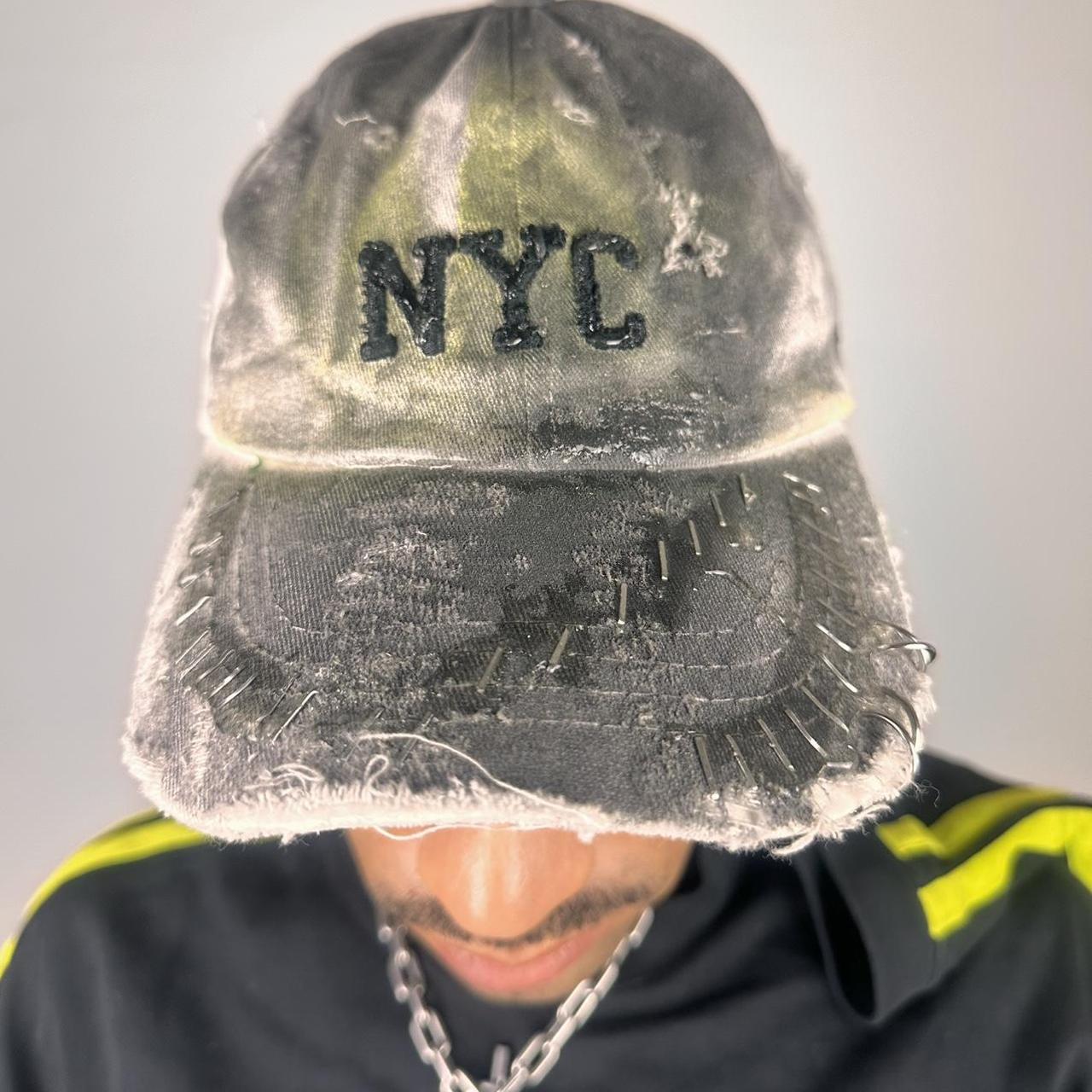 Front of ASTROBOI* white NYC dad hat with clear resin logo, black and green abstract paint details, adjustable strap back