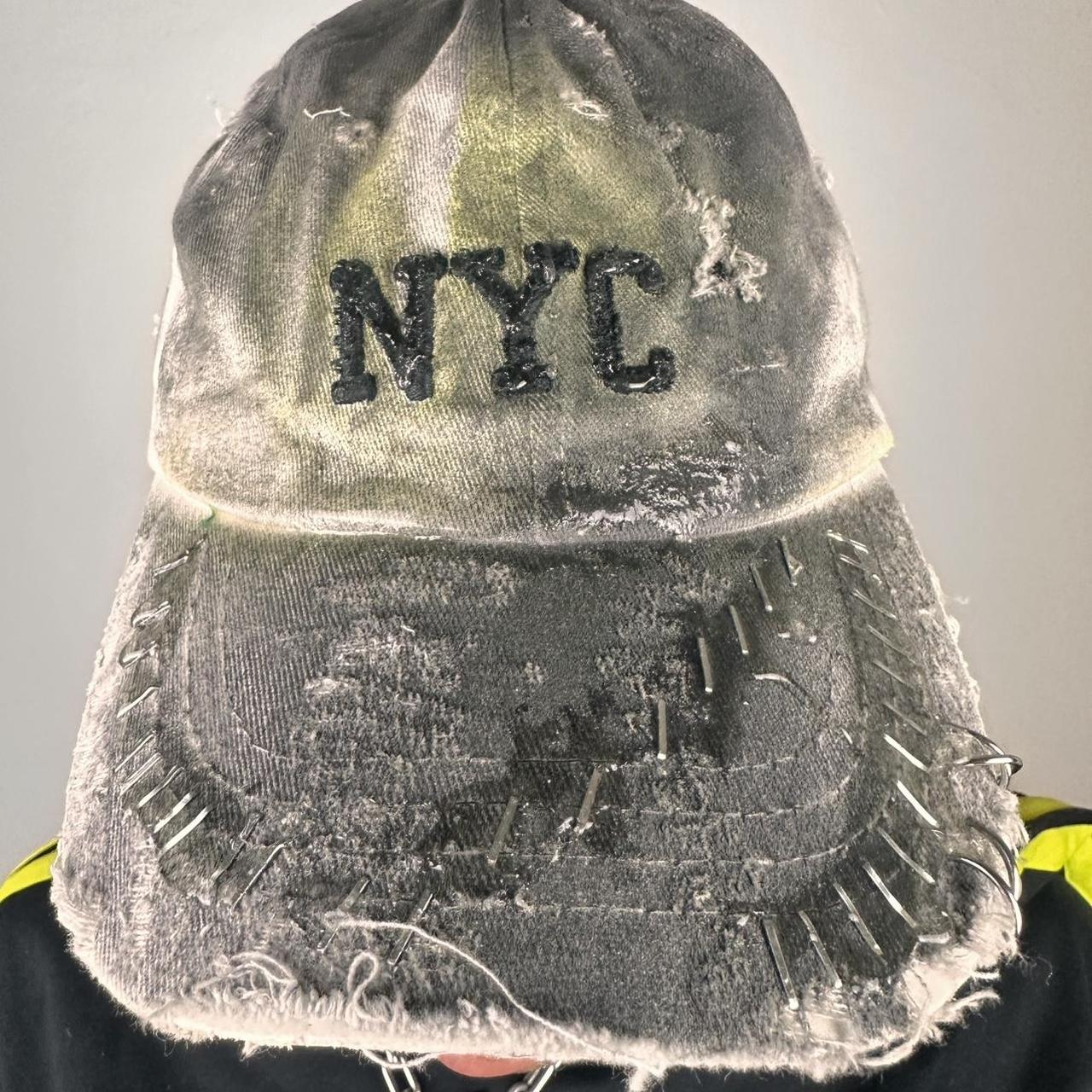 Close up of ASTROBOI* white NYC dad hat with clear resin logo, black and green abstract paint details, adjustable strap back