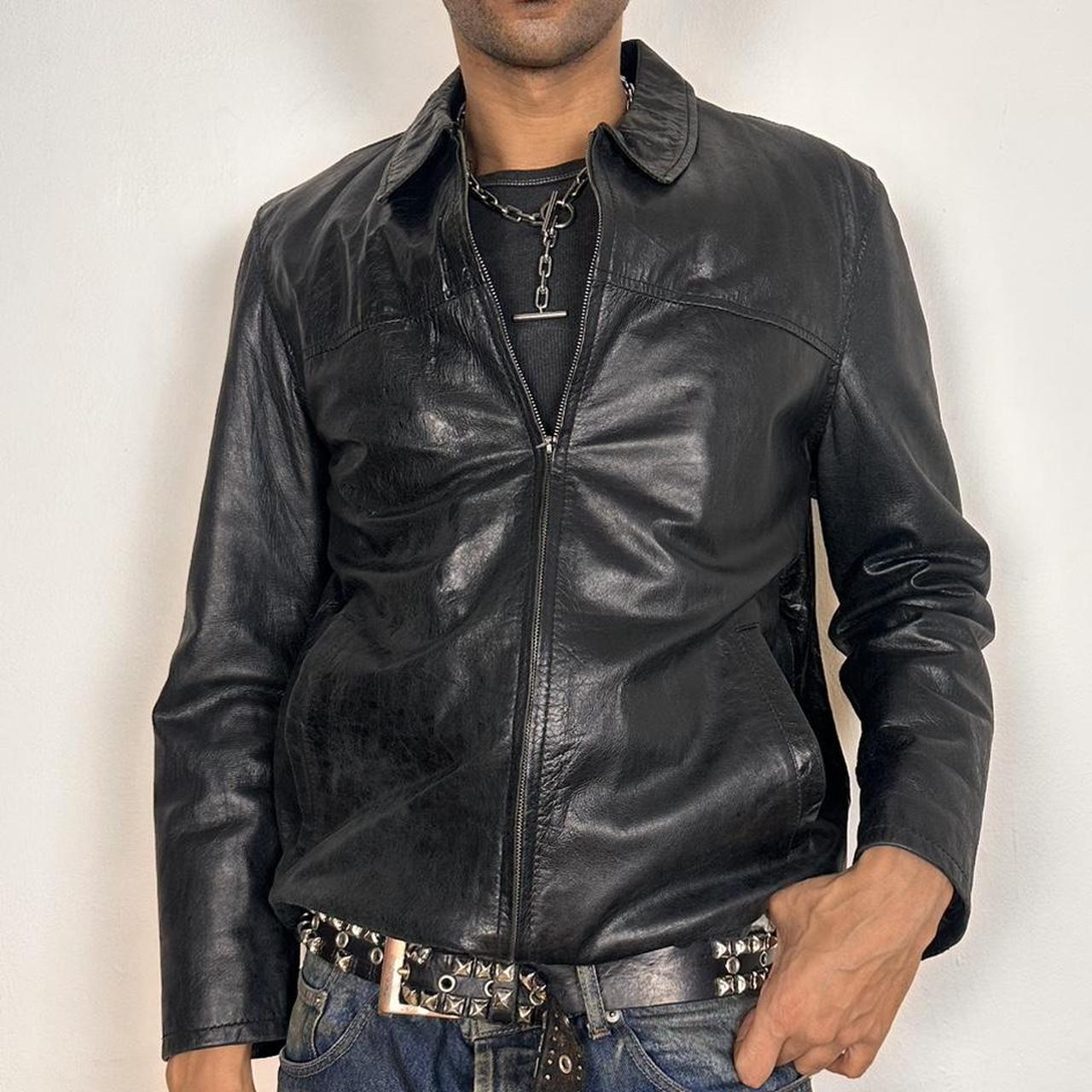 Front of Vintage M. Julian black leather jacket with silver zipper, relaxed fit, and classic minimalist design, shown laid flat, size large.