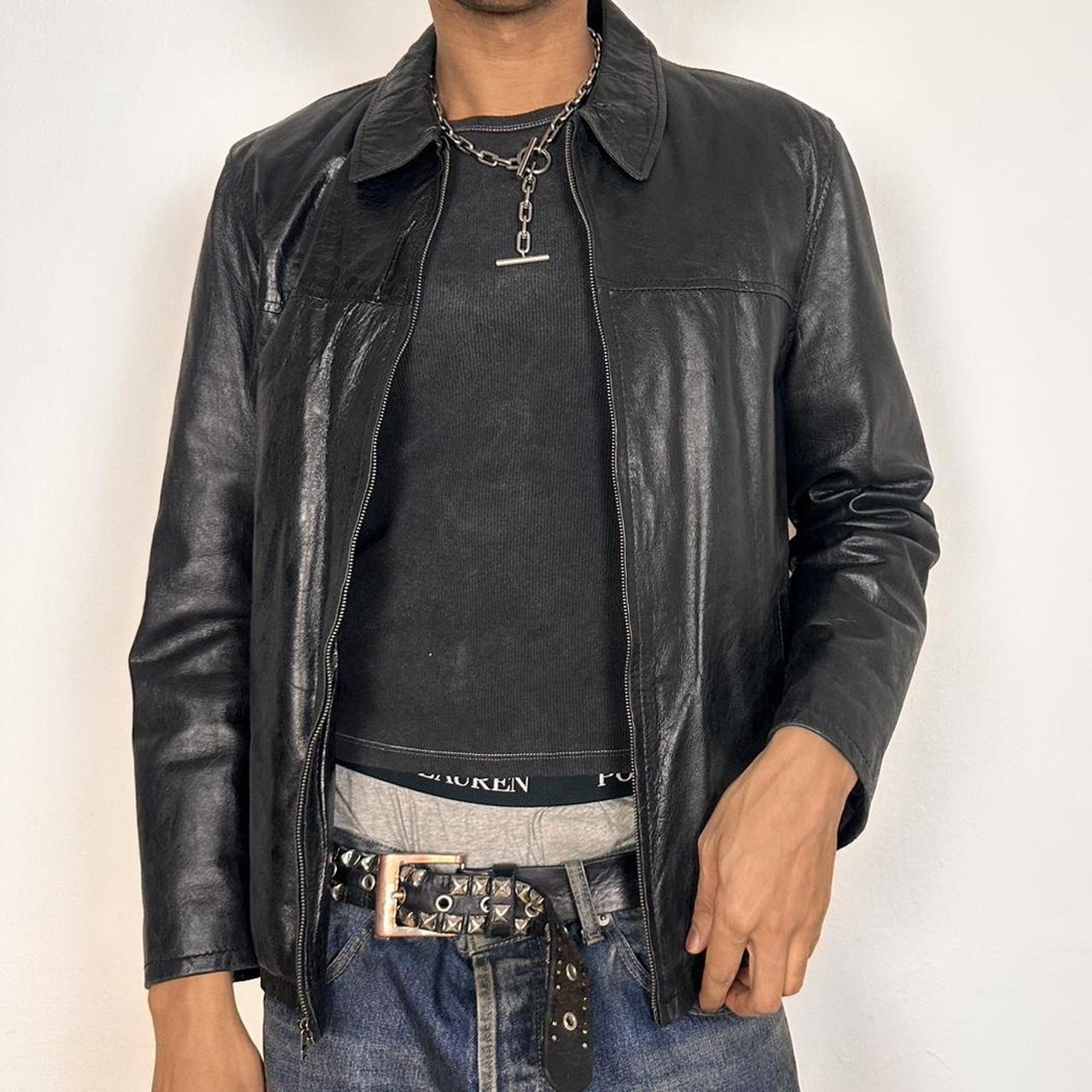 Jacket unzipped on Vintage M. Julian black leather jacket with silver zipper, relaxed fit, and classic minimalist design, shown laid flat, size large.