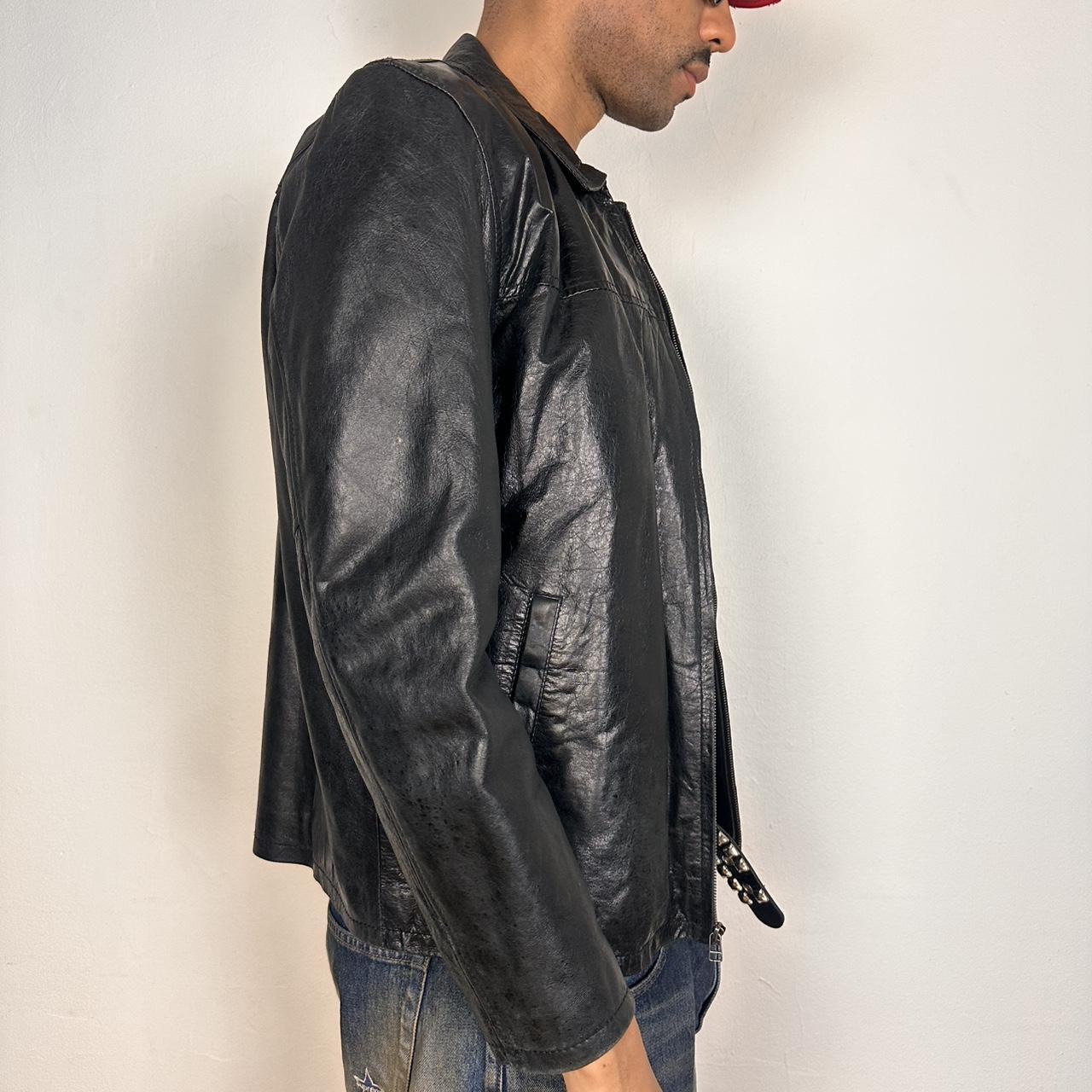 Right side of Vintage M. Julian black leather jacket with silver zipper, relaxed fit, and classic minimalist design, shown laid flat, size large.