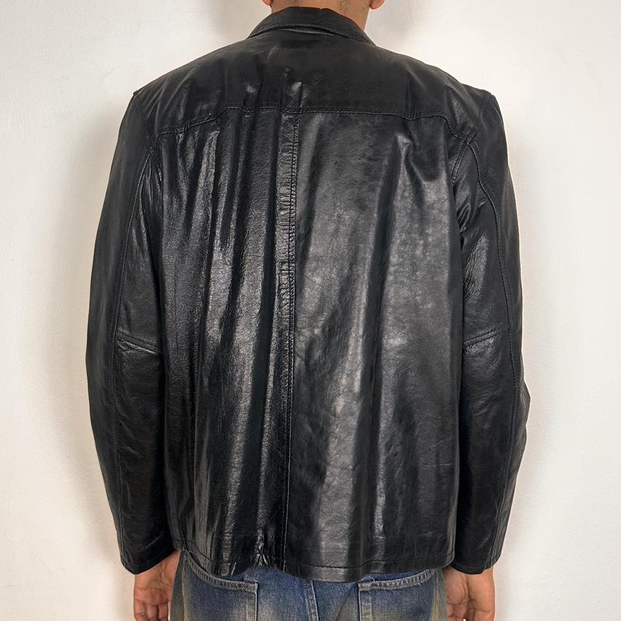 Back side of Vintage M. Julian black leather jacket with silver zipper, relaxed fit, and classic minimalist design, shown laid flat, size large.