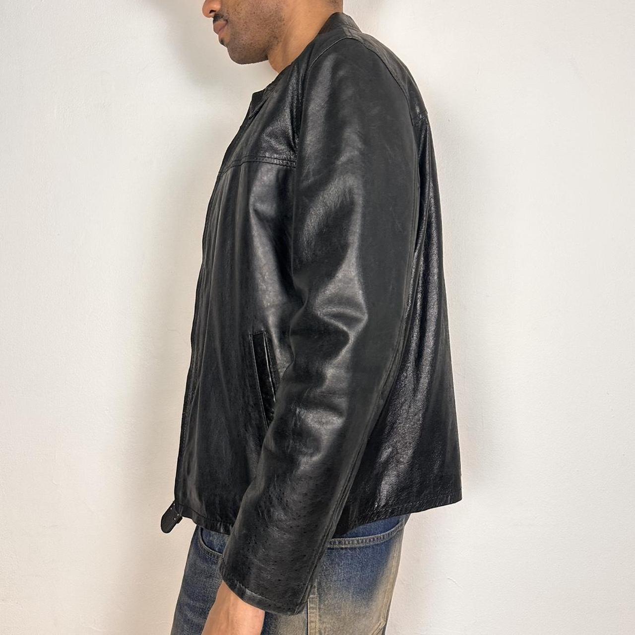 Left side of Vintage M. Julian black leather jacket with silver zipper, relaxed fit, and classic minimalist design, shown laid flat, size large.