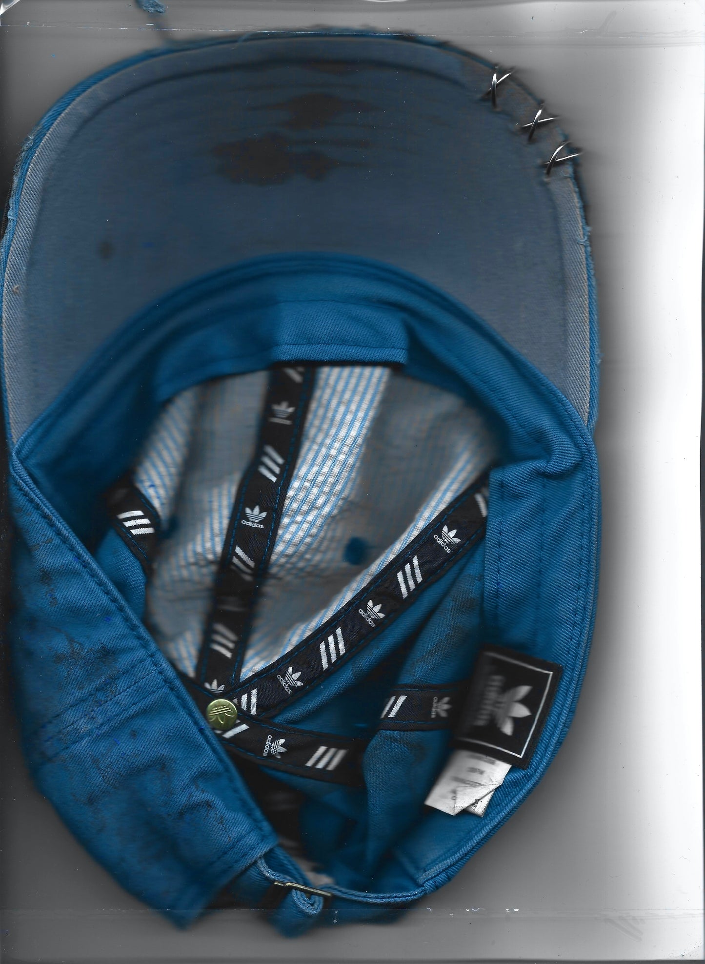 ASTROBOI* x Adidas 'H Chic' tan distressed grunge hat, rear view showing black duct tape accent detail and adjustable strap. Scanned artistic image back. 