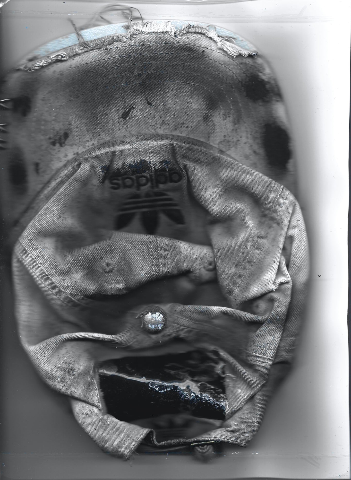Scanned front image of ASTROBOI* x Adidas 'H Chic' tan distressed grunge hat, rear view showing black duct tape accent detail and adjustable strap. 