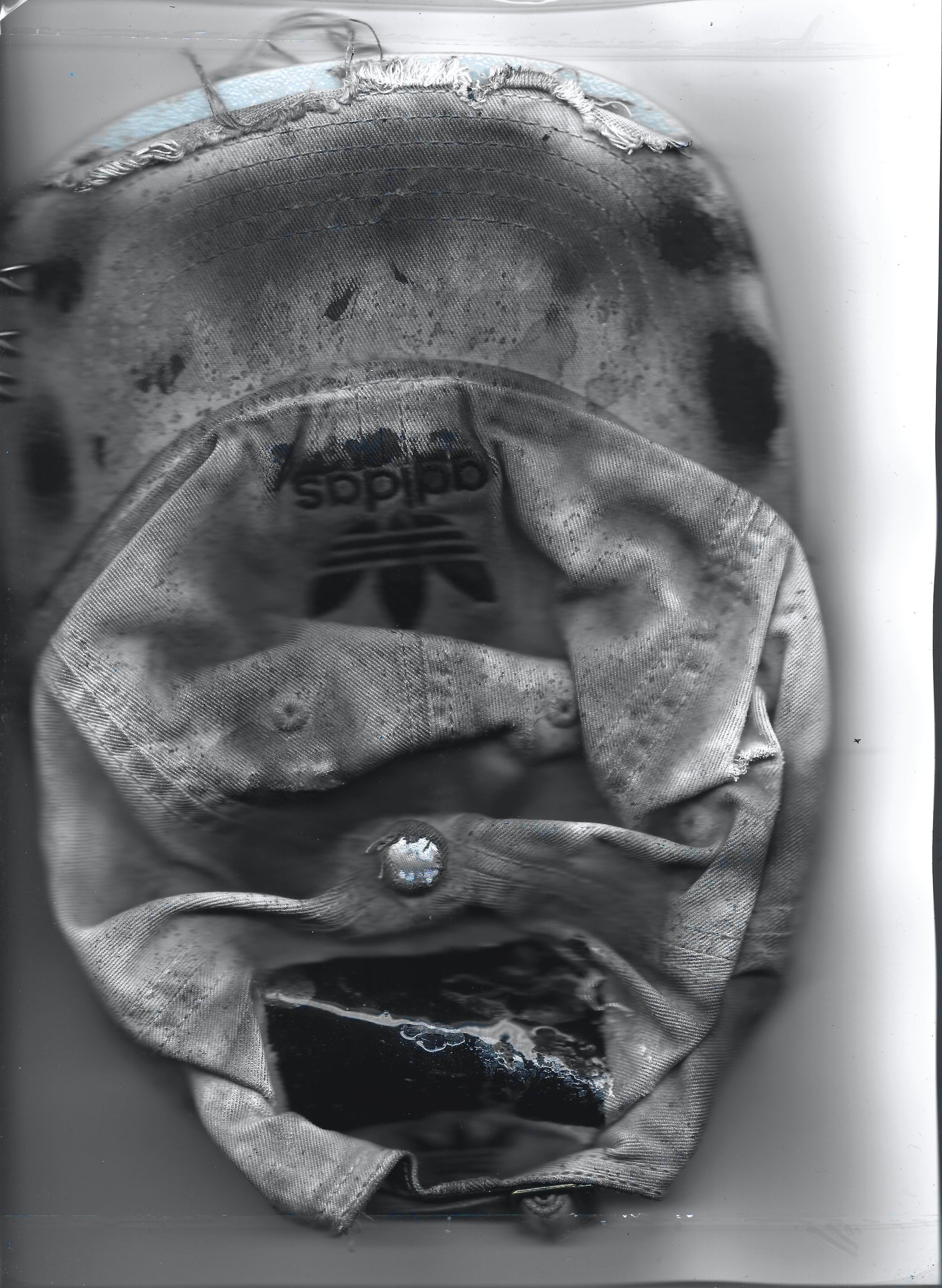 Scanned front image of ASTROBOI* x Adidas 'H Chic' tan distressed grunge hat, rear view showing black duct tape accent detail and adjustable strap. 