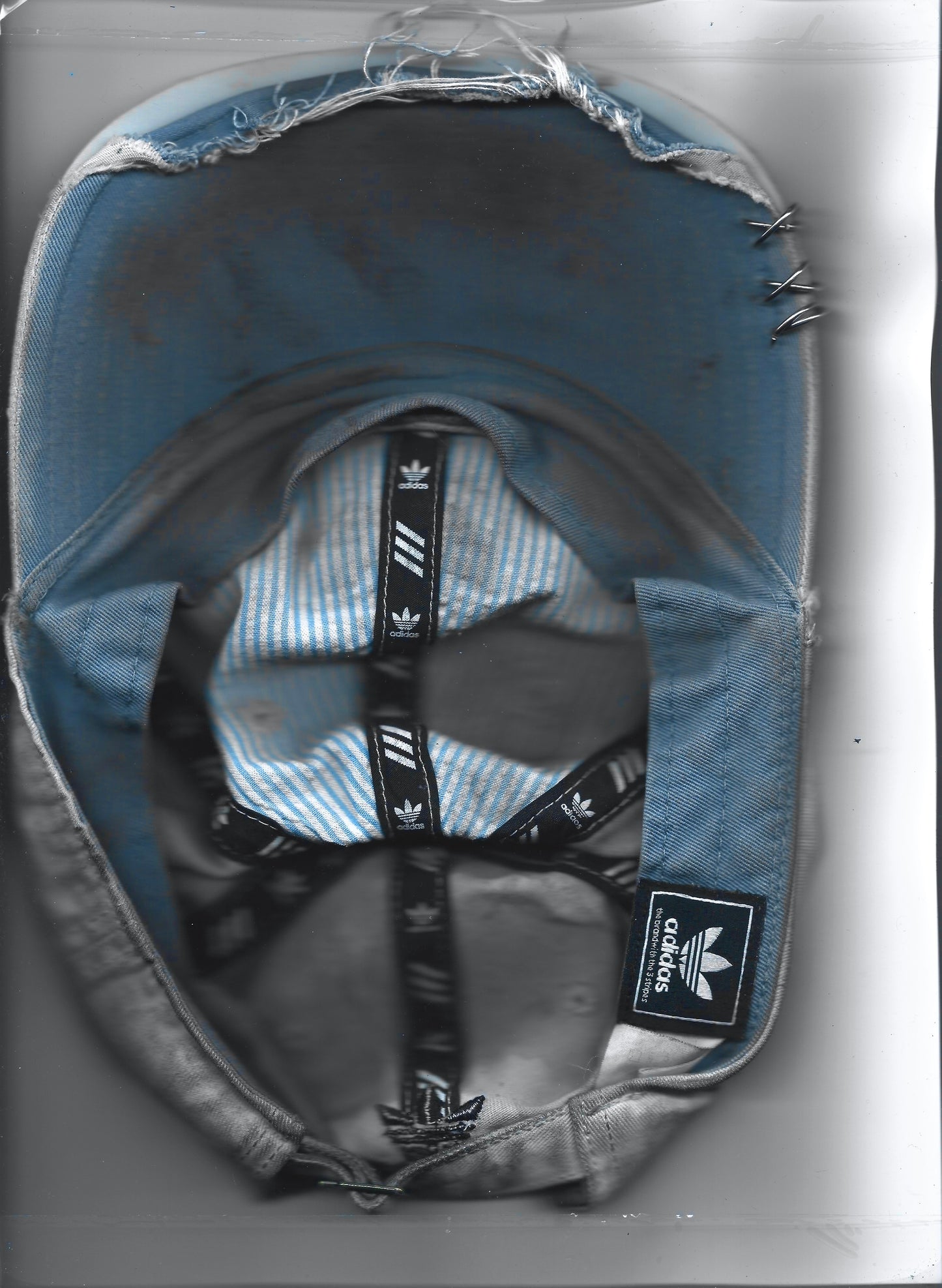 Scanned back image of ASTROBOI* x Adidas 'H Chic' tan distressed grunge hat, rear view showing black duct tape accent detail and adjustable strap. 
