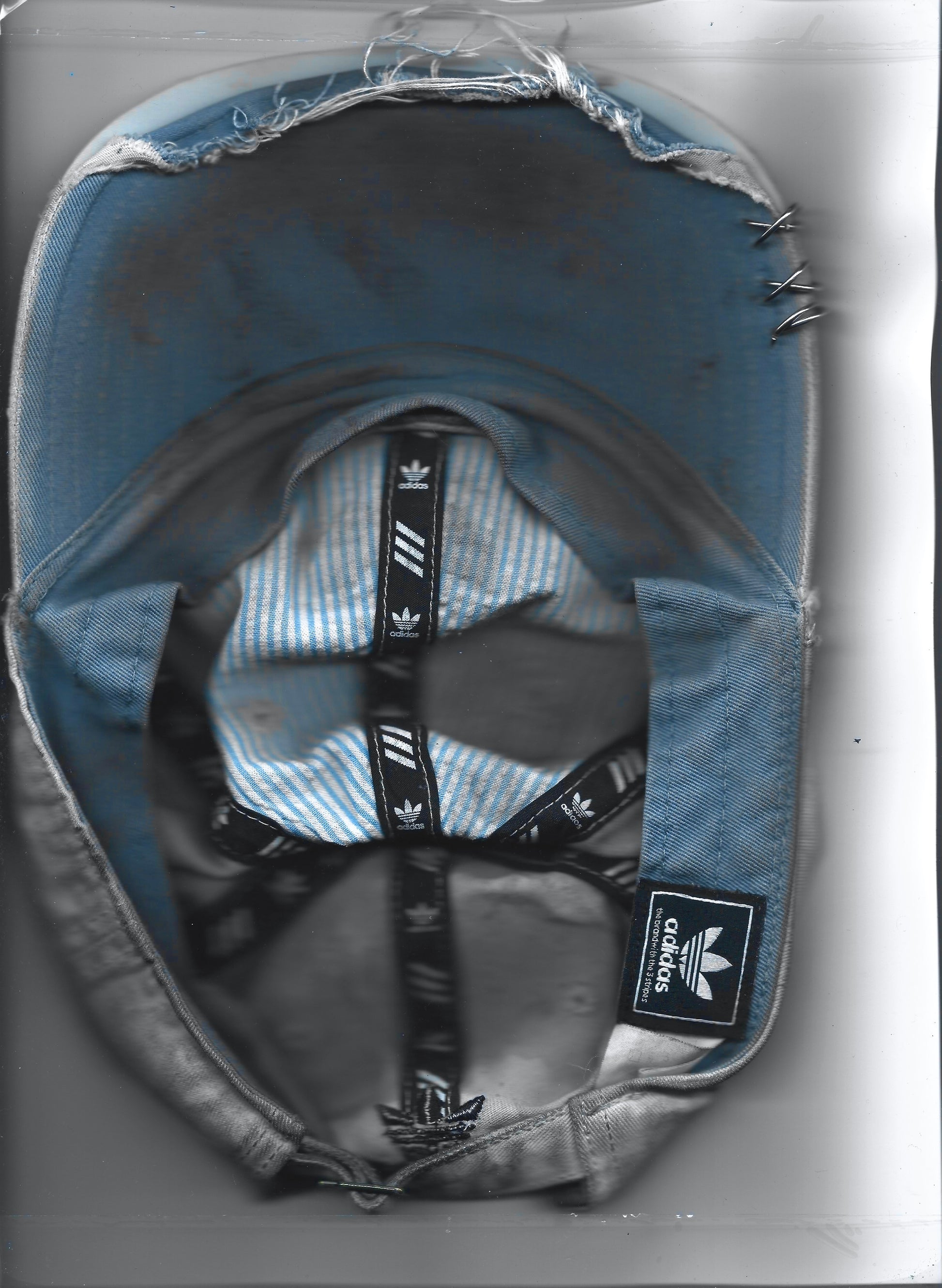 Scanned back image of ASTROBOI* x Adidas 'H Chic' tan distressed grunge hat, rear view showing black duct tape accent detail and adjustable strap. 