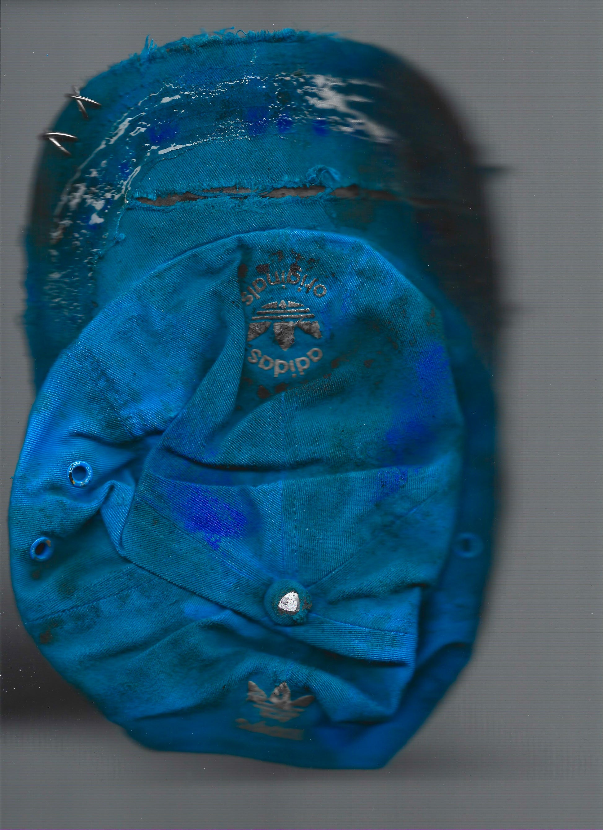 Scanned image of ASTROBOI* x Adidas 'Nebula' blue distressed pierced hat, back view showing white Adidas back logo and adjustable strap.