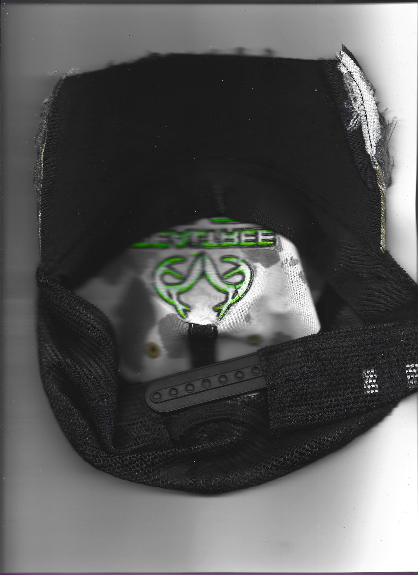 Scanned image of ASTROBOI* x RealTree 'Edge' brown camo rhinestone cap, rear view showing mesh ventilated back panel and adjustable strap.