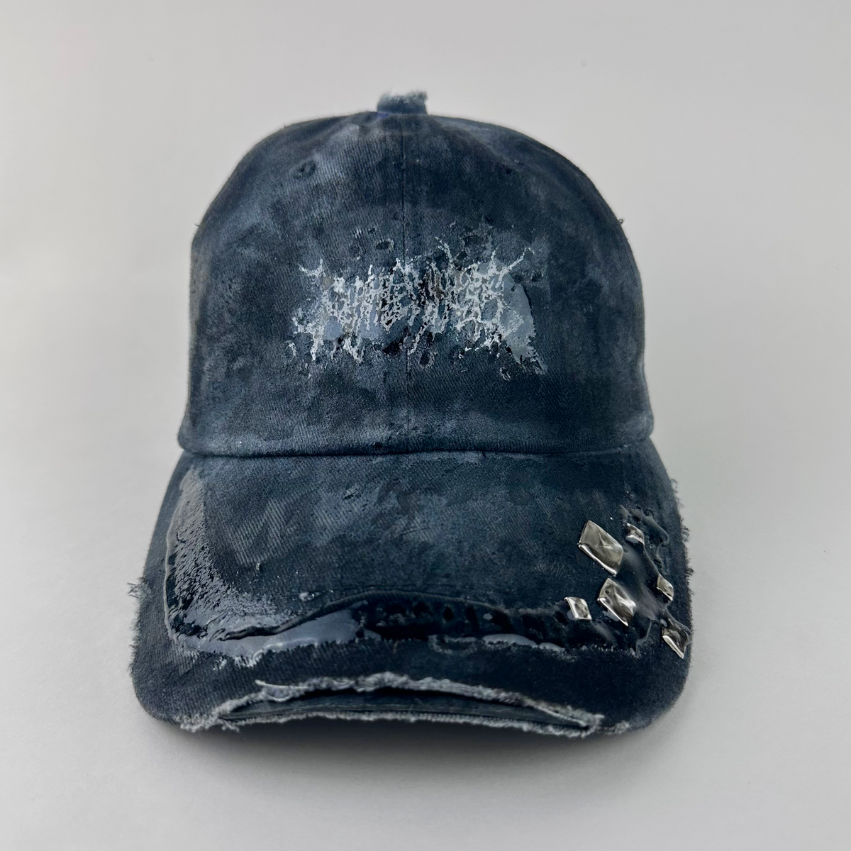 ASTROBOI* 'Slick' black and gray indie studded cap with white indie barbed wire logo at front, silver studded visor detail, and 3D resin coating, front view.