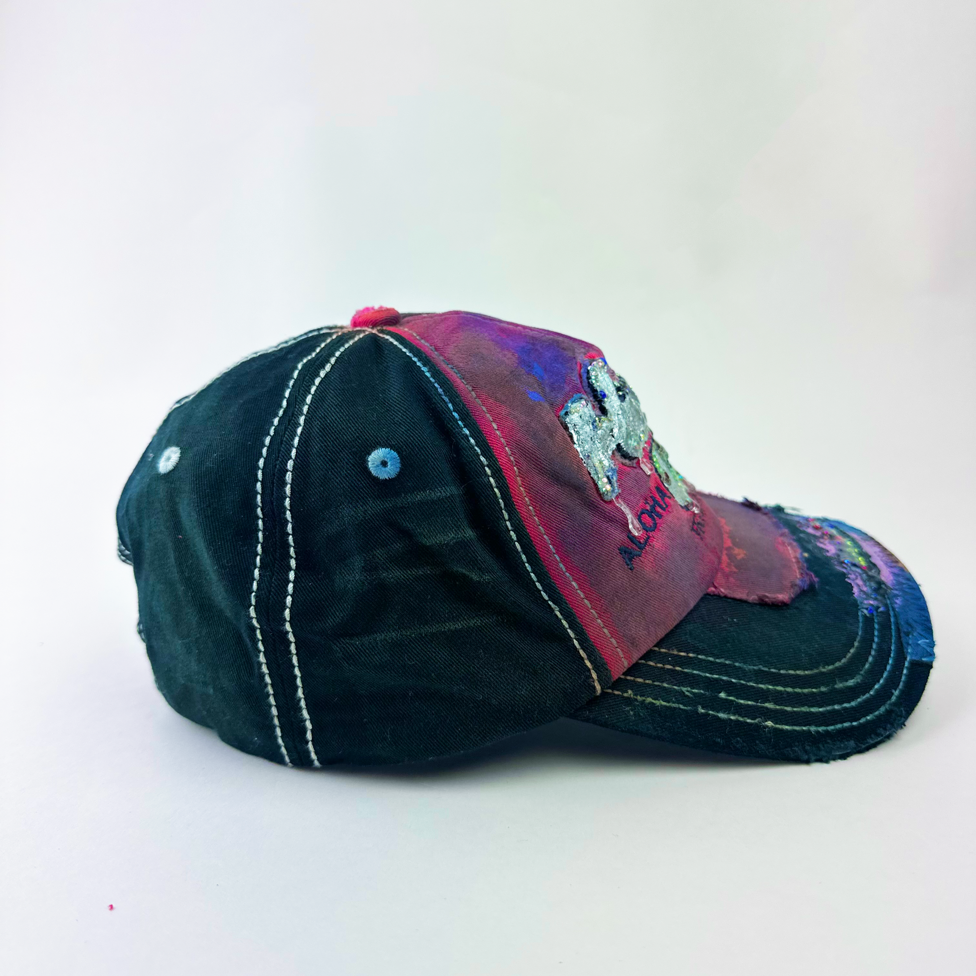 Right side detail of ASTROBOI* 'Tropicale' showing purple and pink paint splatter and metallic rhinestone embellishments on red and black Y2K base.