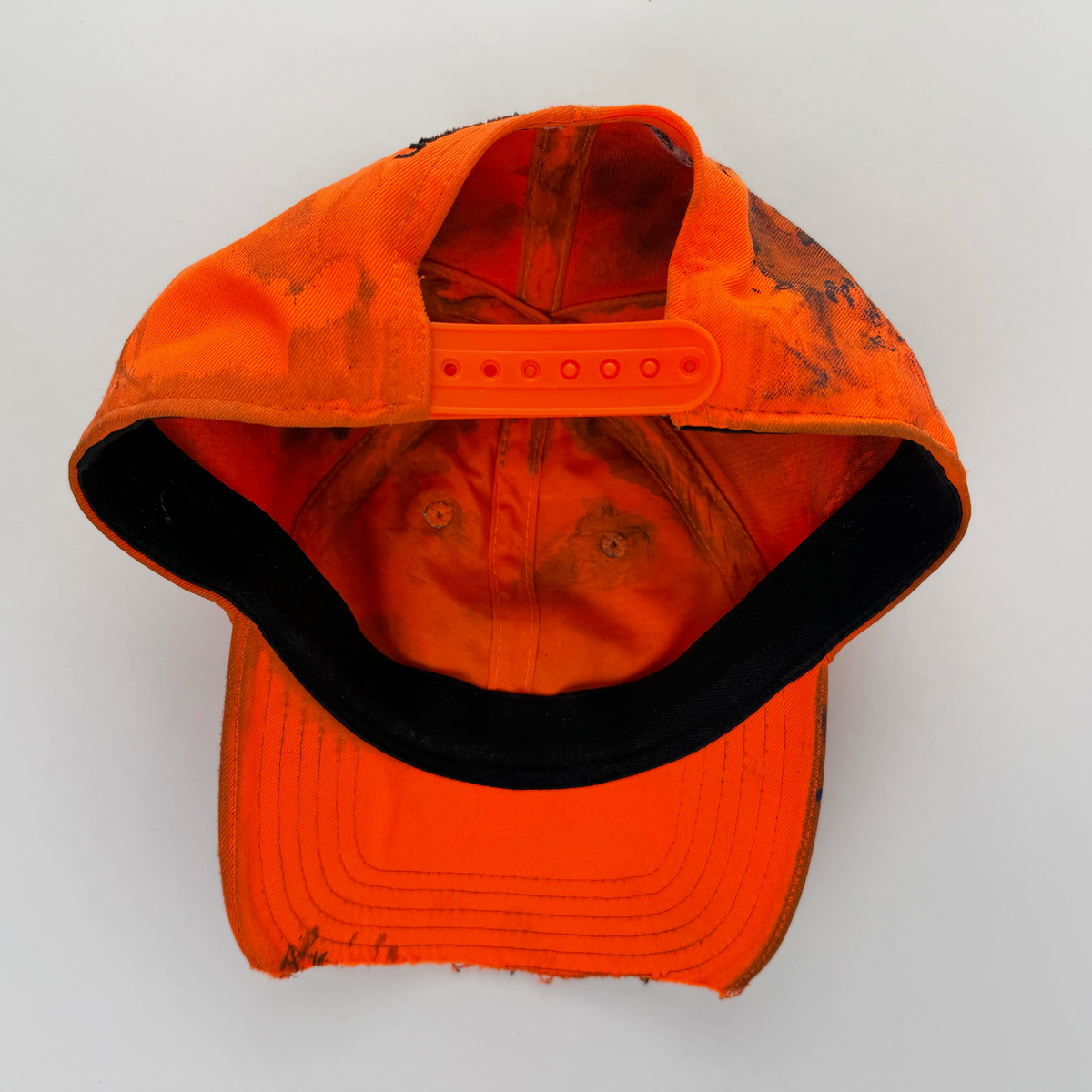 ASTROBOI* x Under Armour ‘Solar Flare’ orange and blue futuristic rhinestone cap, rear view showing adjustable strap back.