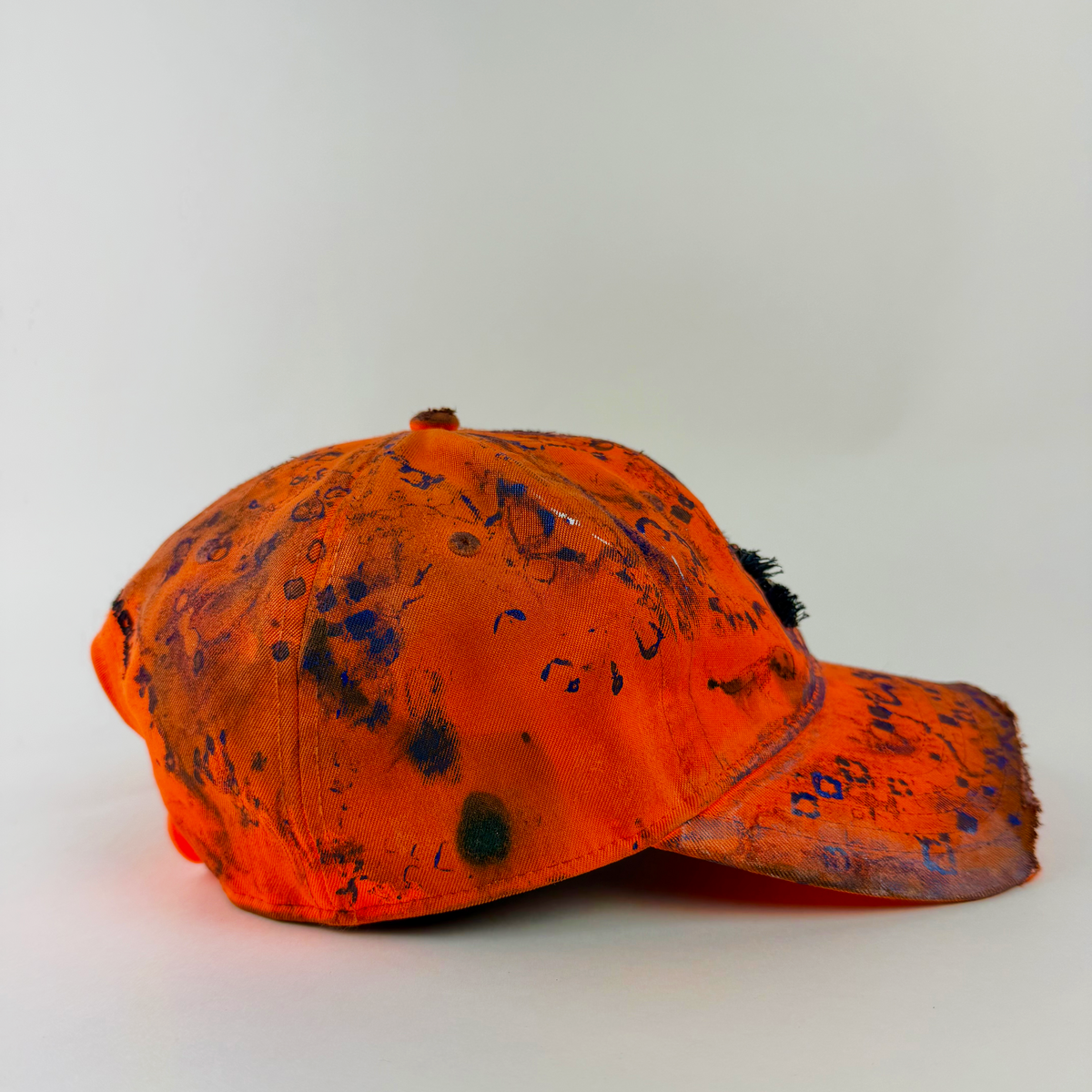 Right side detail of ASTROBOI* x Under Armour ‘Solar Flare’ showing partially sawed-off visor and hand drawn blue abstract design on faded orange base.
