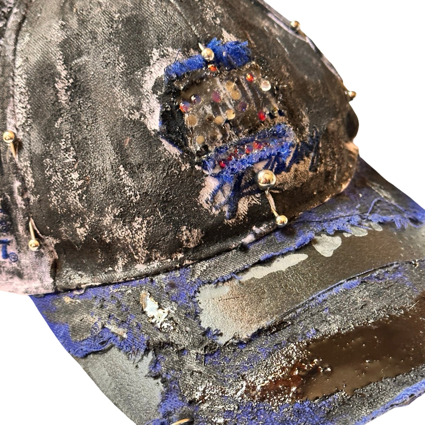 Flat front detail of Blue and white ASTROBOI* NAPA hat with rhinestone-covered logo sealed in clear resin, stainless steel piercings, and a deconstructed visor, handcrafted in NYC.