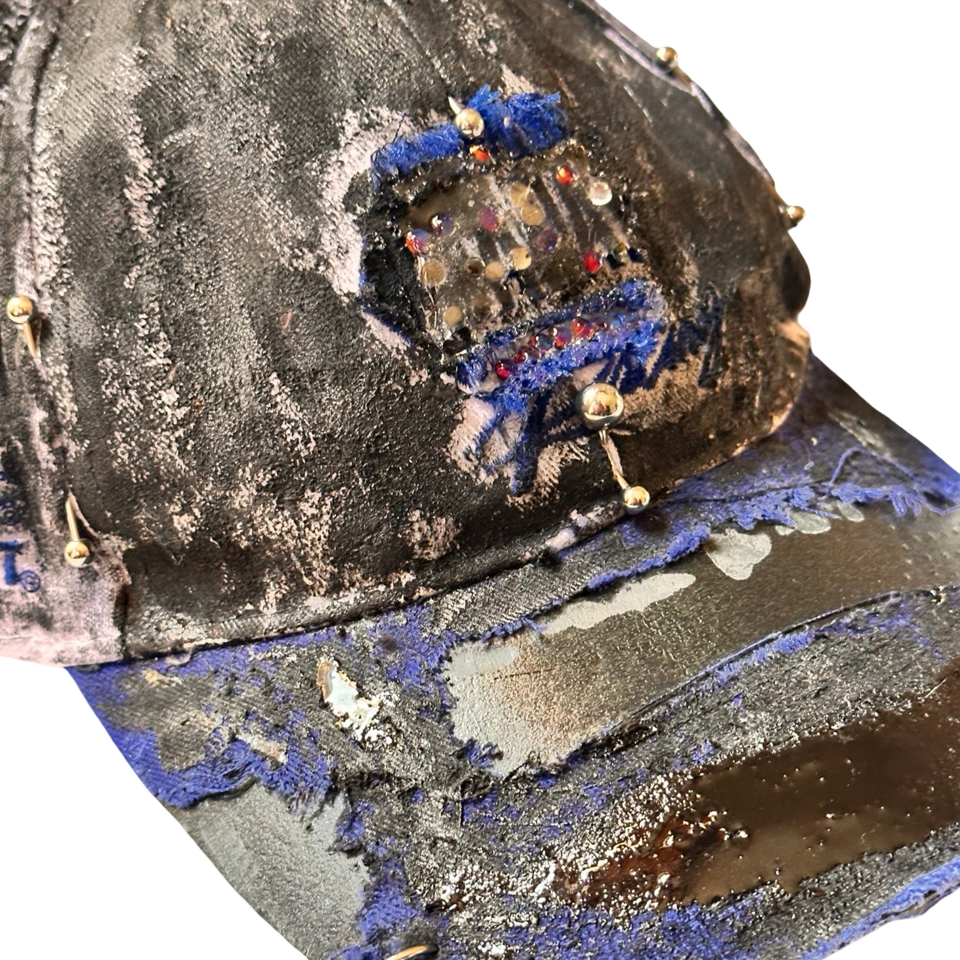 Flat front detail of Blue and white ASTROBOI* NAPA hat with rhinestone-covered logo sealed in clear resin, stainless steel piercings, and a deconstructed visor, handcrafted in NYC.