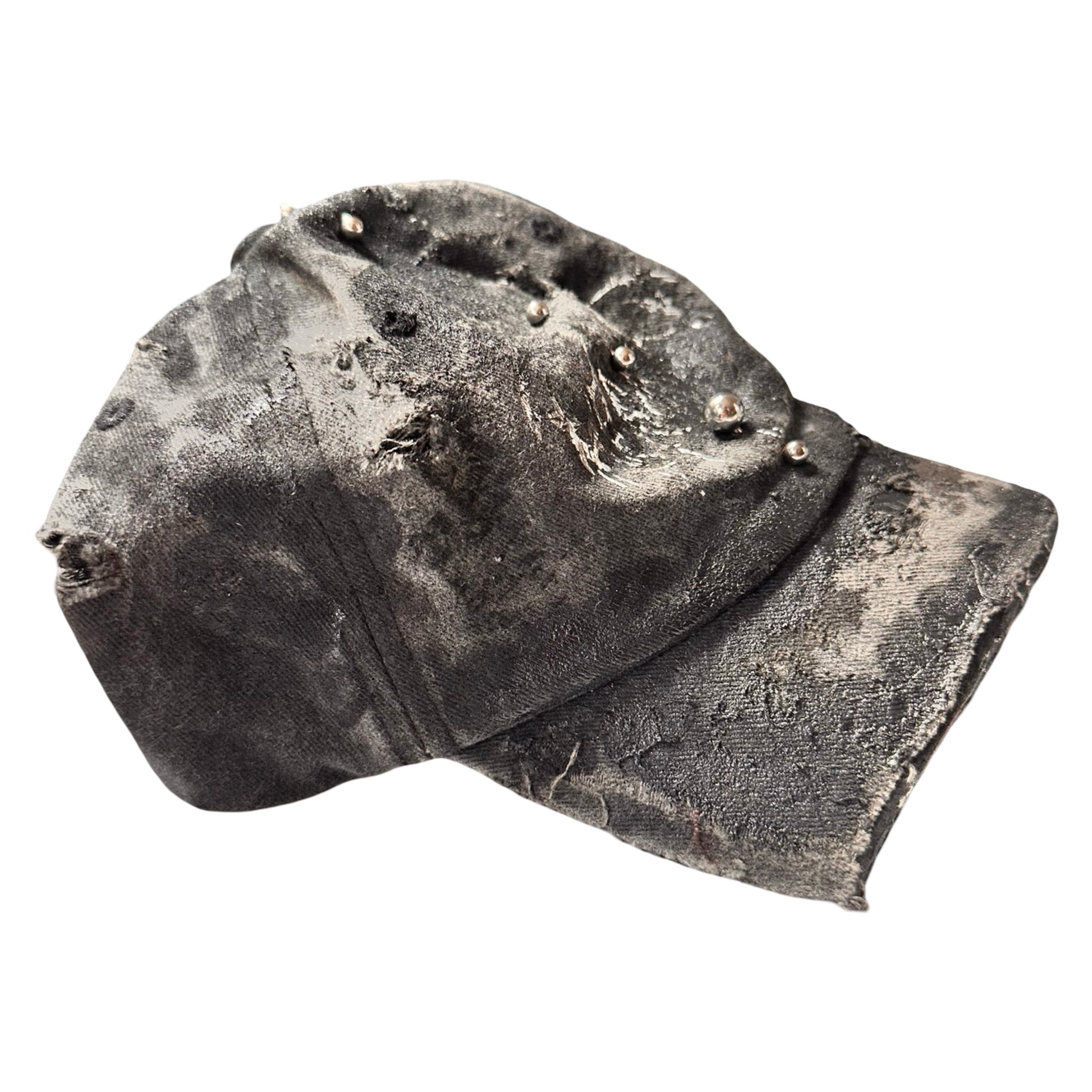 Flat right of Black distressed half-visor hat with barbed-wire logo, adjustable strap, black paint details, and stainless steel piercings along the brim.