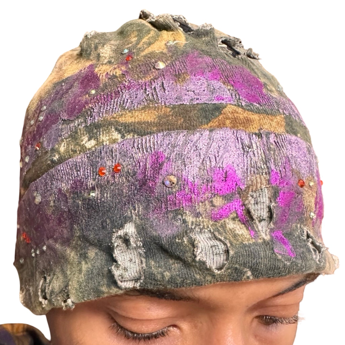 Front detail of ASTROBOI* brown RealTree grunge beanie with ripped details, lavender and magenta paint, and colorful rhinestones, handmade in NYC.