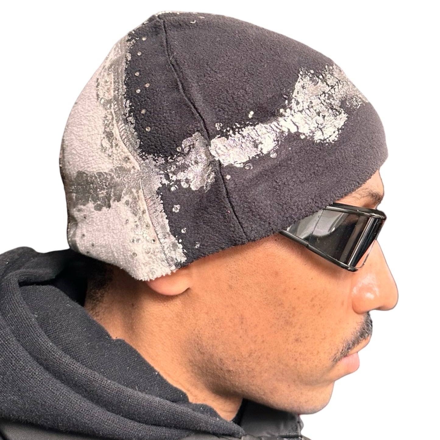 Right side of ASTROBOI* black and white fleece beanie with silver rhinestone paint and tonal rhinestones. Custom handmade winter hat from ASTROBOI* STUDIO in NYC.