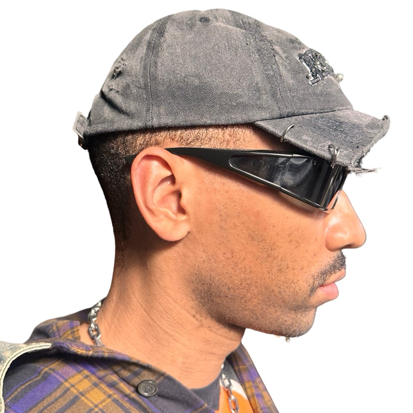 Right side of Black half-visor “New York” hat with embroidered front logo, stainless steel piercings, and an adjustable strap.