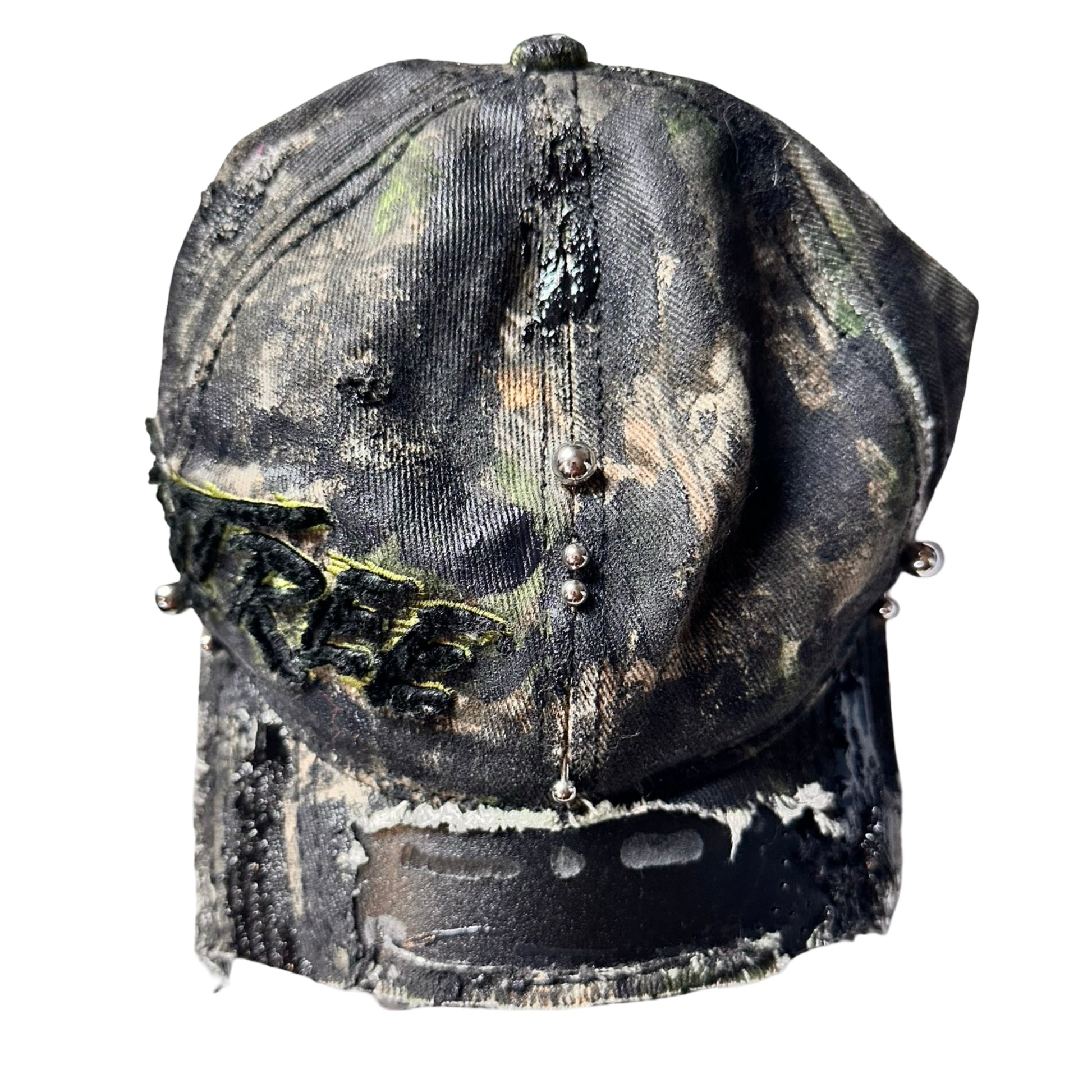 Flat front of Brown RealTree distressed half-visor hat with elastic base, black resin detailing, and a sawed-off visor for a deconstructed Y2K aesthetic.
