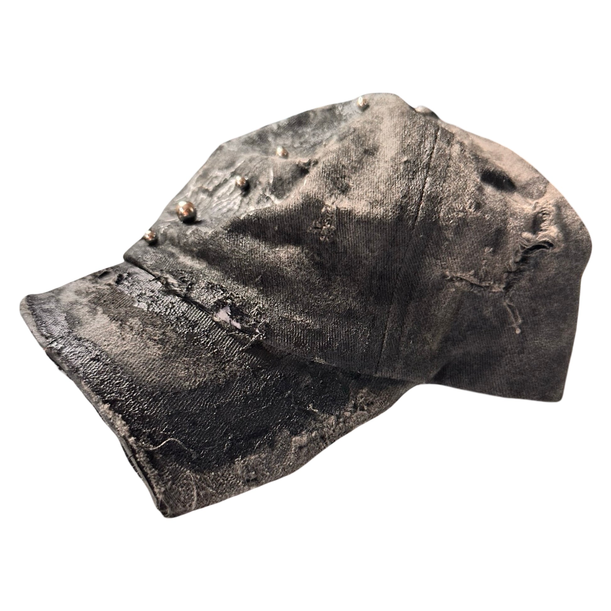 Front right of Black distressed half-visor hat with barbed-wire logo, adjustable strap, black paint details, and stainless steel piercings along the brim.