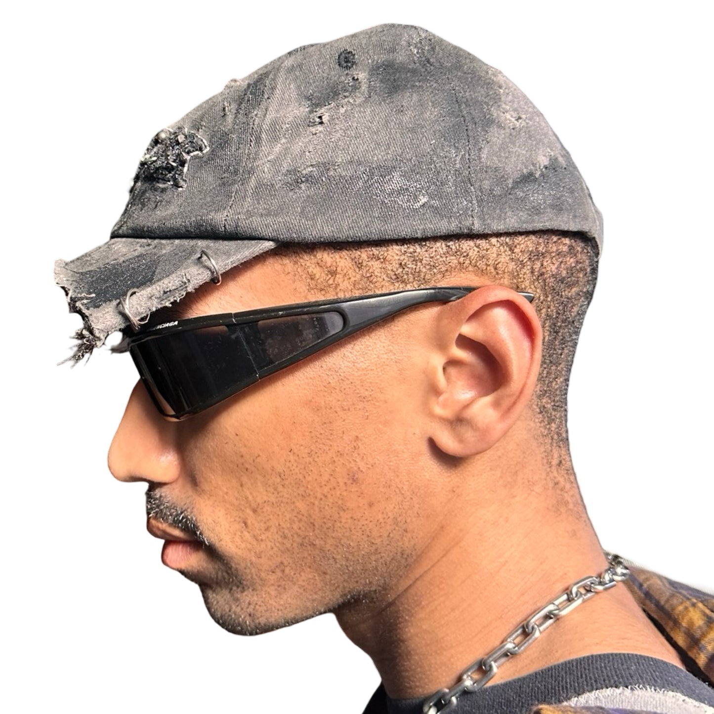 Left side of Black half-visor “New York” hat with embroidered front logo, stainless steel piercings, and an adjustable strap.