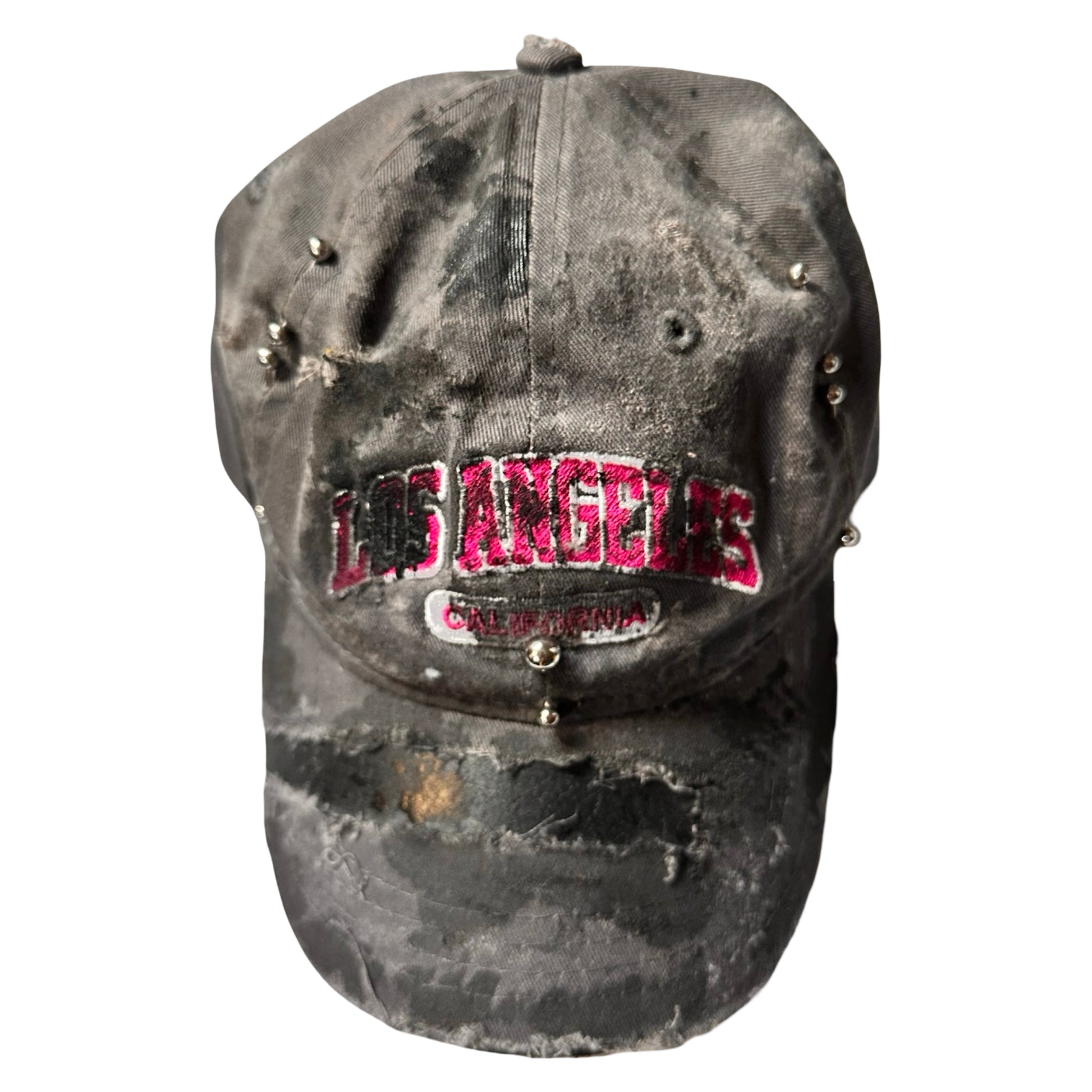 Flat front of Grey and pink distressed half-visor hat with ‘Los Angeles’ embroidery, black paint, and stainless steel piercings, customized by ASTROBOI*.