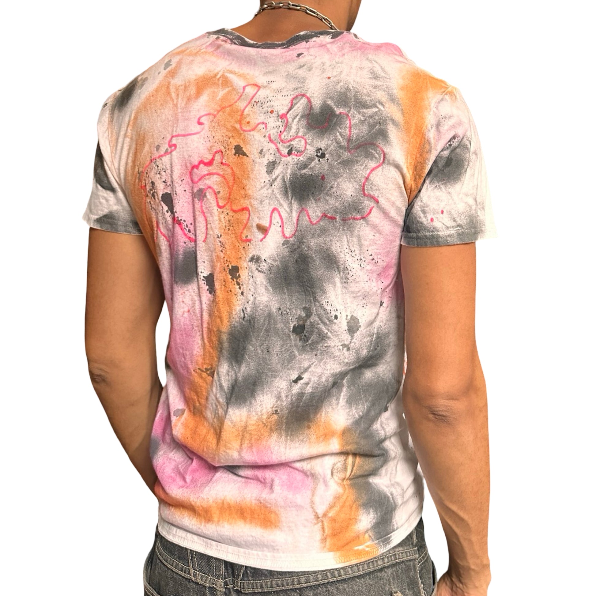 Person wearing a tie-dye t-shirt with abstract patterns on a white background
