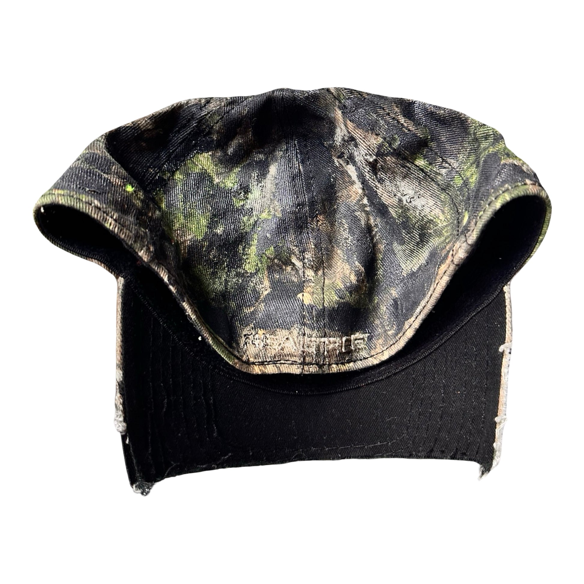 Flat back side of Brown RealTree distressed half-visor hat with elastic base, black resin detailing, and a sawed-off visor for a deconstructed Y2K aesthetic.