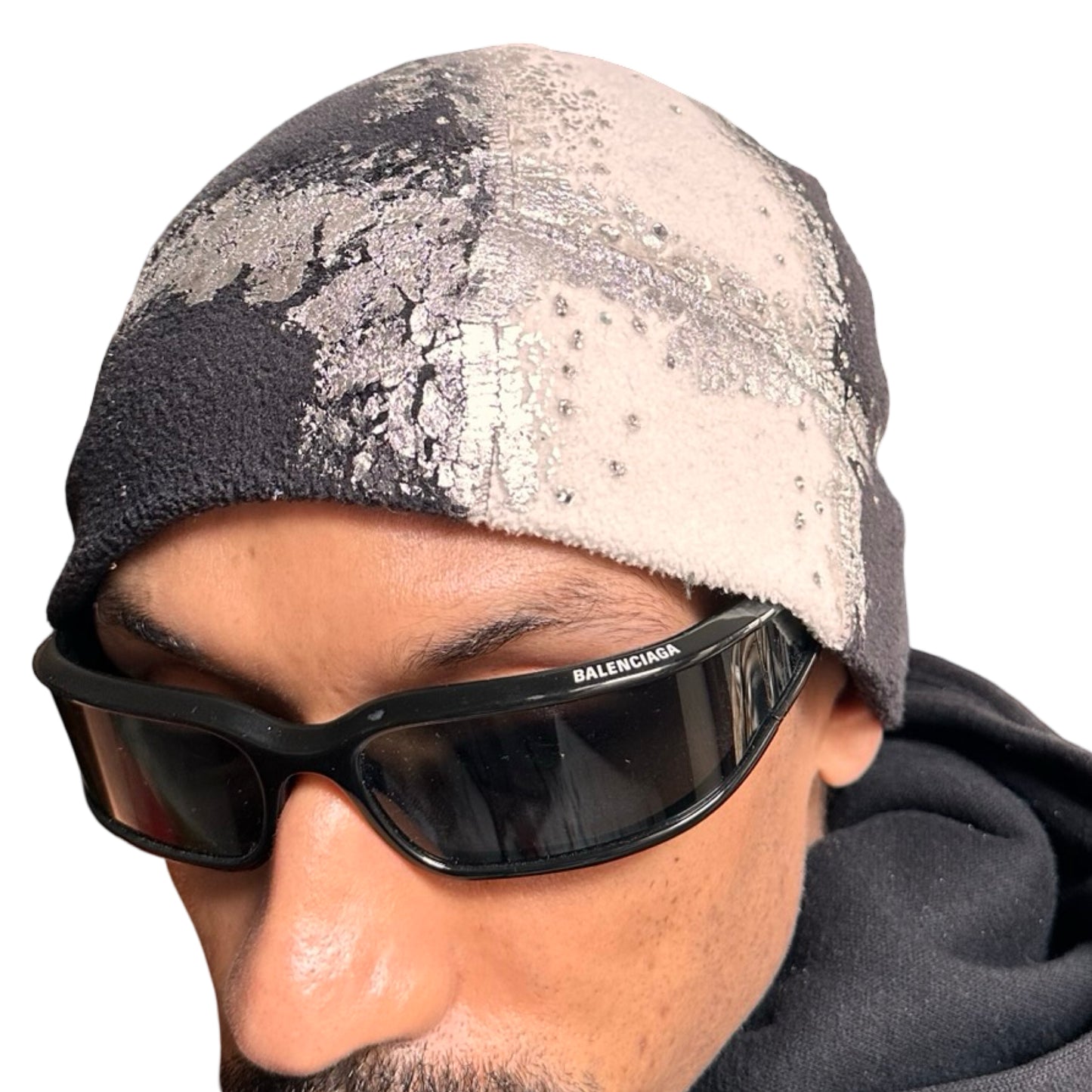 Close up of ASTROBOI* black and white fleece beanie with silver rhinestone paint and tonal rhinestones. Custom handmade winter hat from ASTROBOI* STUDIO in NYC.