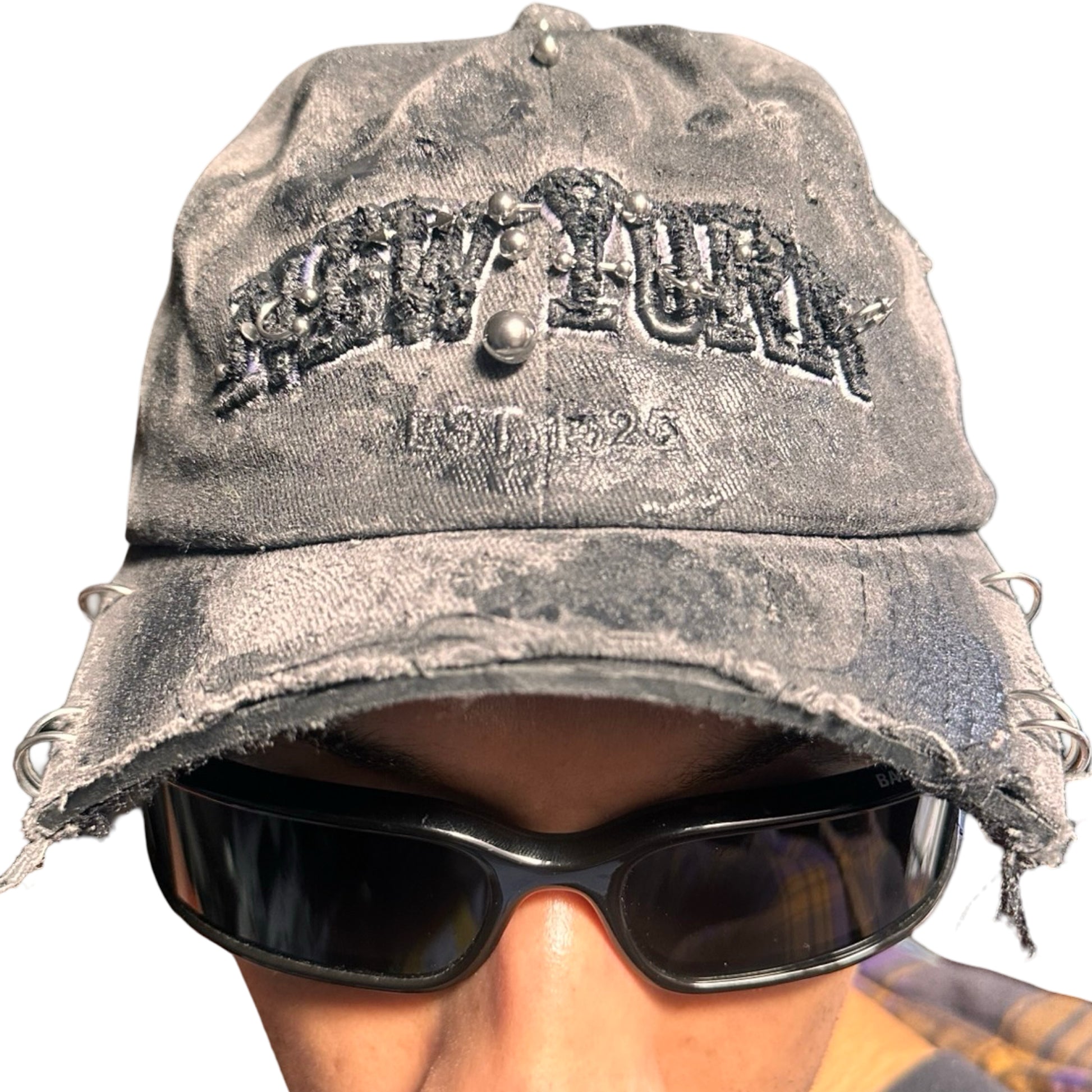 Front of Black half-visor “New York” hat with embroidered front logo, stainless steel piercings, and an adjustable strap.