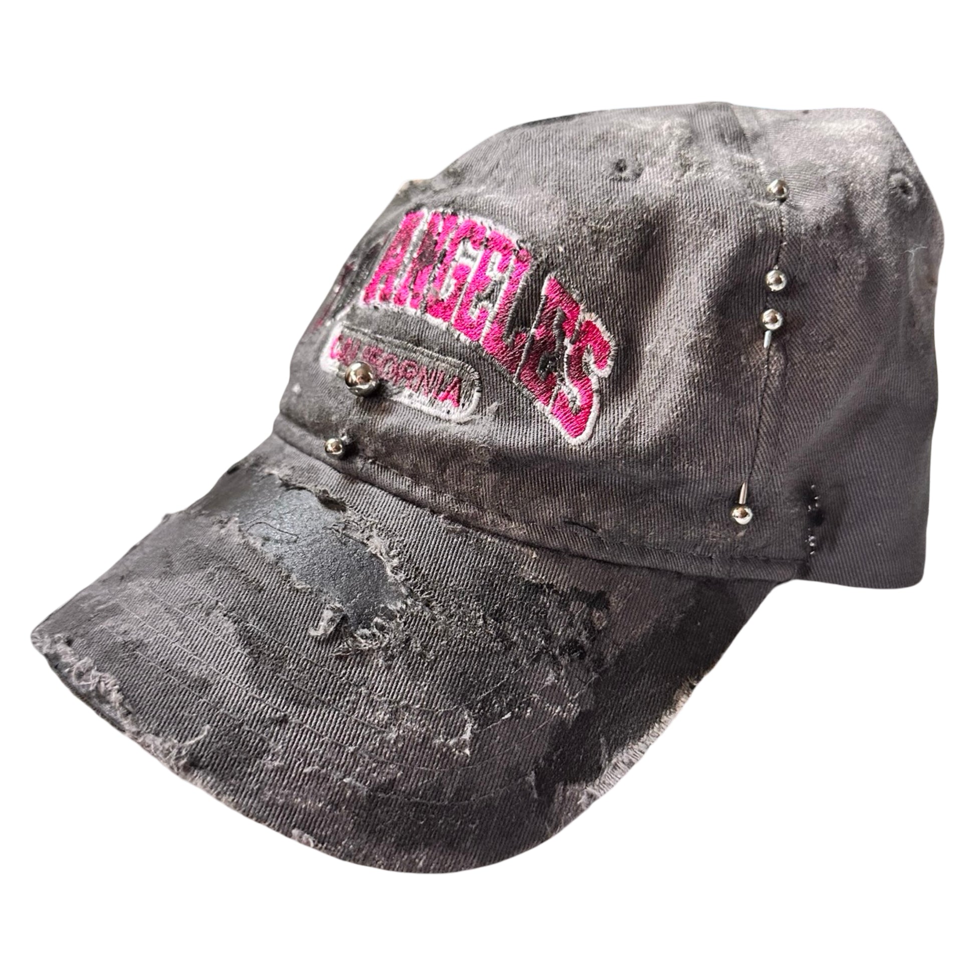 Front right side of Grey and pink distressed half-visor hat with ‘Los Angeles’ embroidery, black paint, and stainless steel piercings, customized by ASTROBOI*.