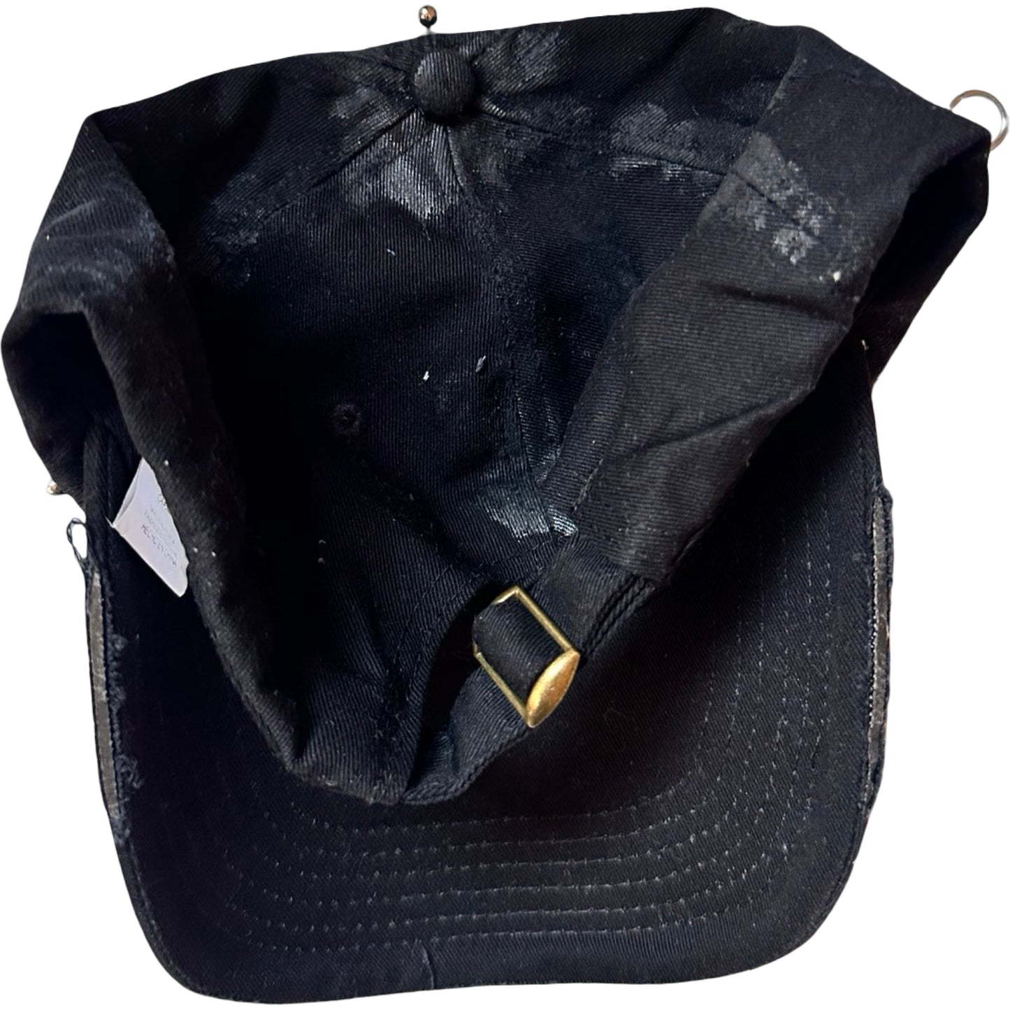 Flat back of Black distressed ASTROBOI* ‘Daddy’ hat with custom paint detailing and stainless steel piercings, handcrafted in NYC.
