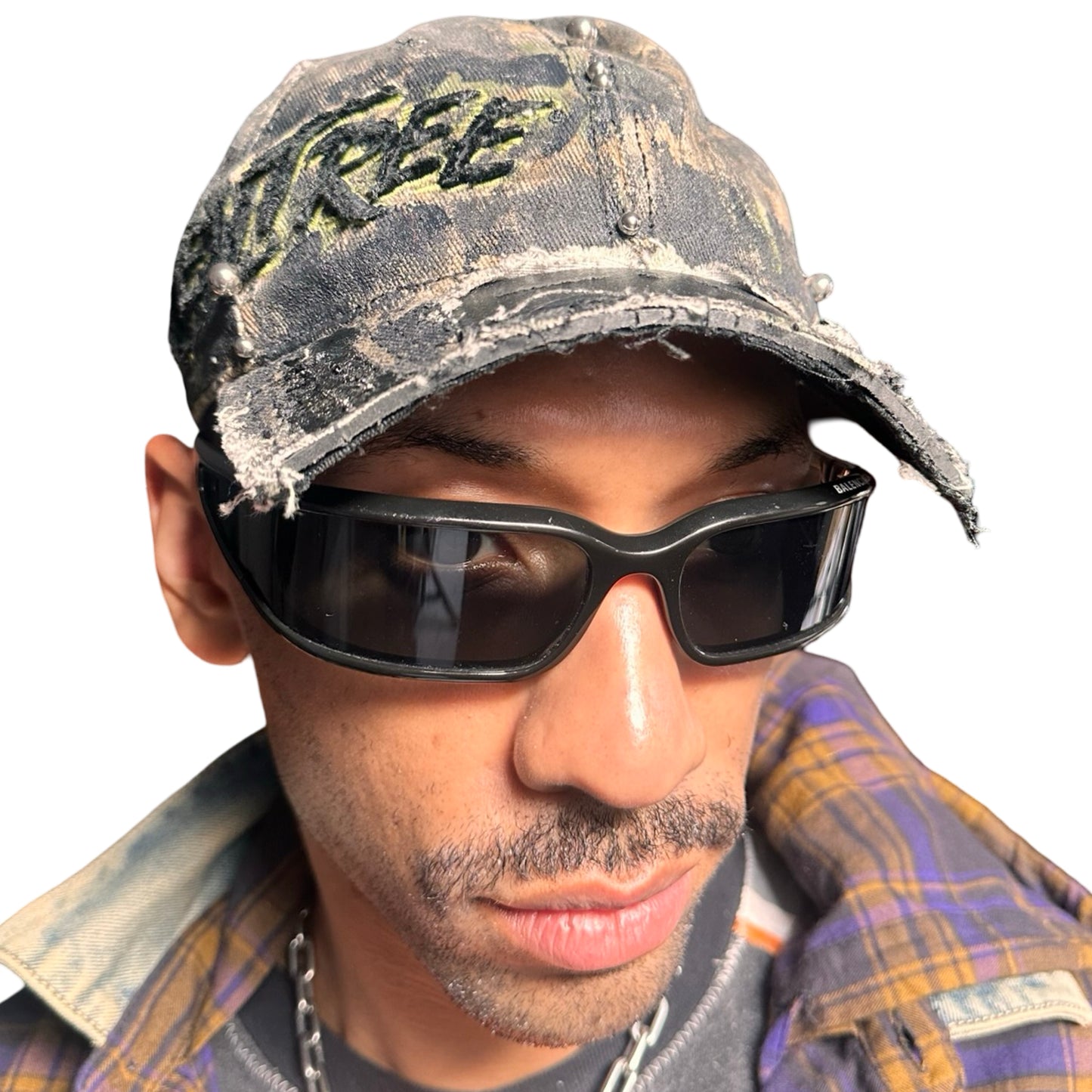 Front of Brown RealTree distressed half-visor hat with elastic base, black resin detailing, and a sawed-off visor for a deconstructed Y2K aesthetic.