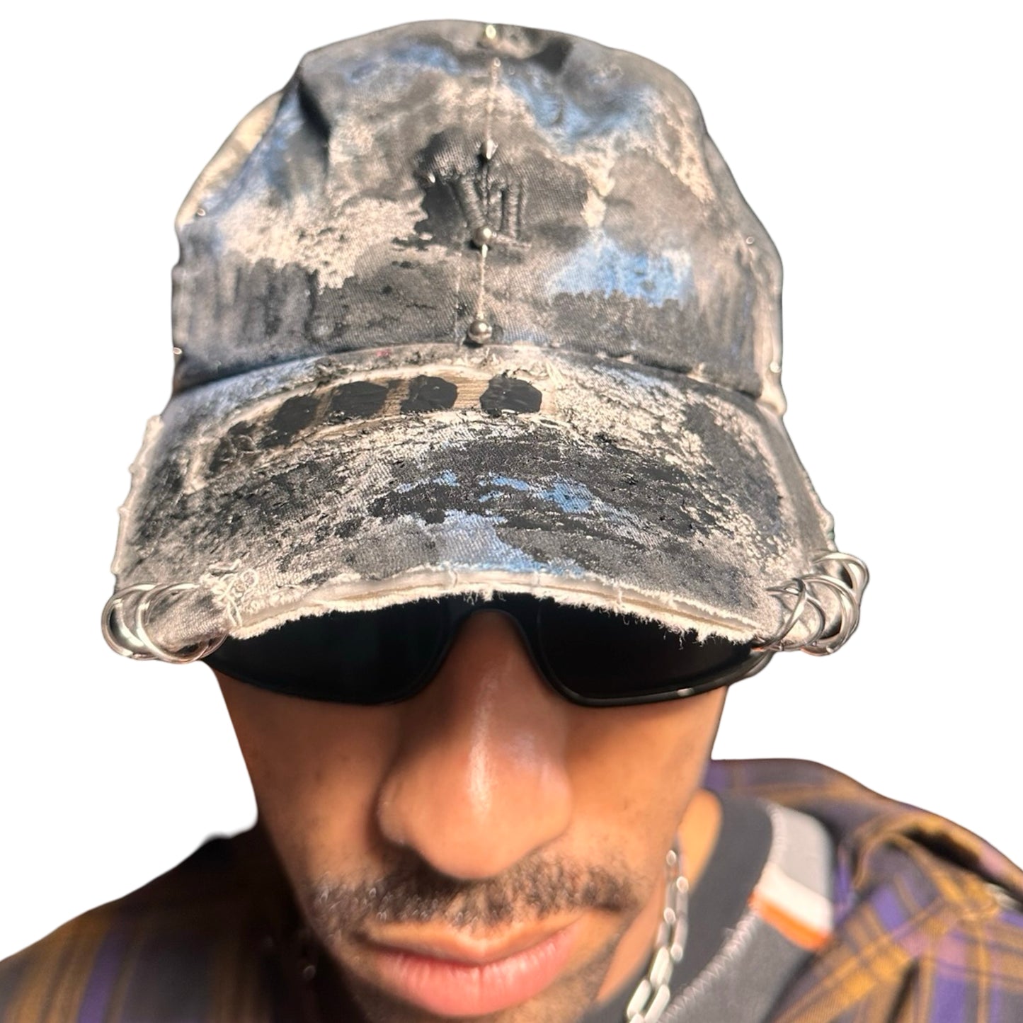 Front of Black Vuori baseball hat customized by ASTROBOI* with blue and black painted details, stainless steel piercings, and an embroidered V logo.