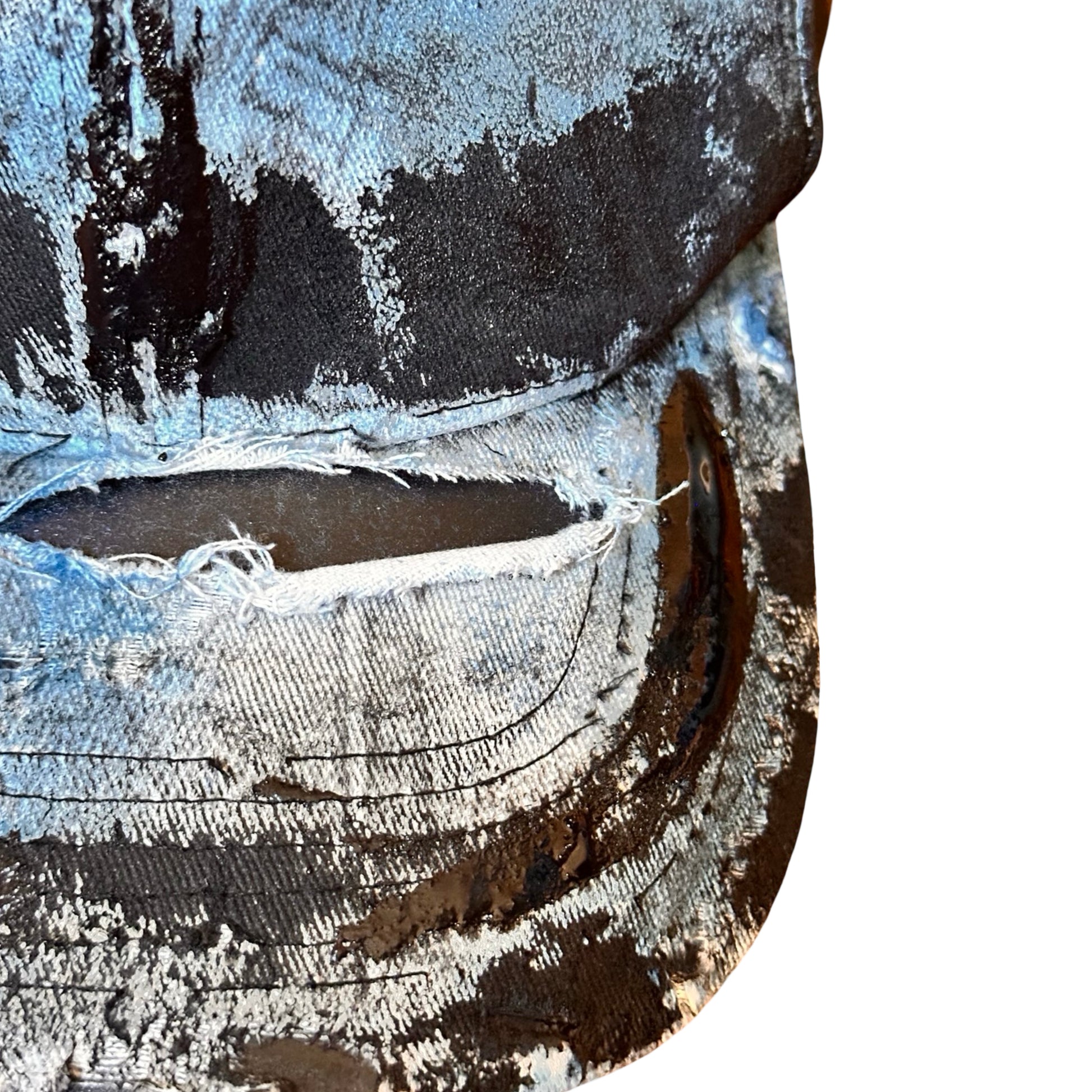 Front flat visor close up of ASTROBOI* white trompe l’oeil denim print hat with blue and black paint, resin accents, and distressed detailing.
