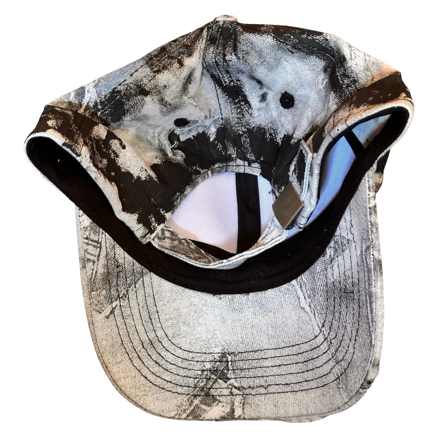 Flat back of ASTROBOI* white trompe l’oeil denim print hat with blue and black paint, resin accents, and distressed detailing.